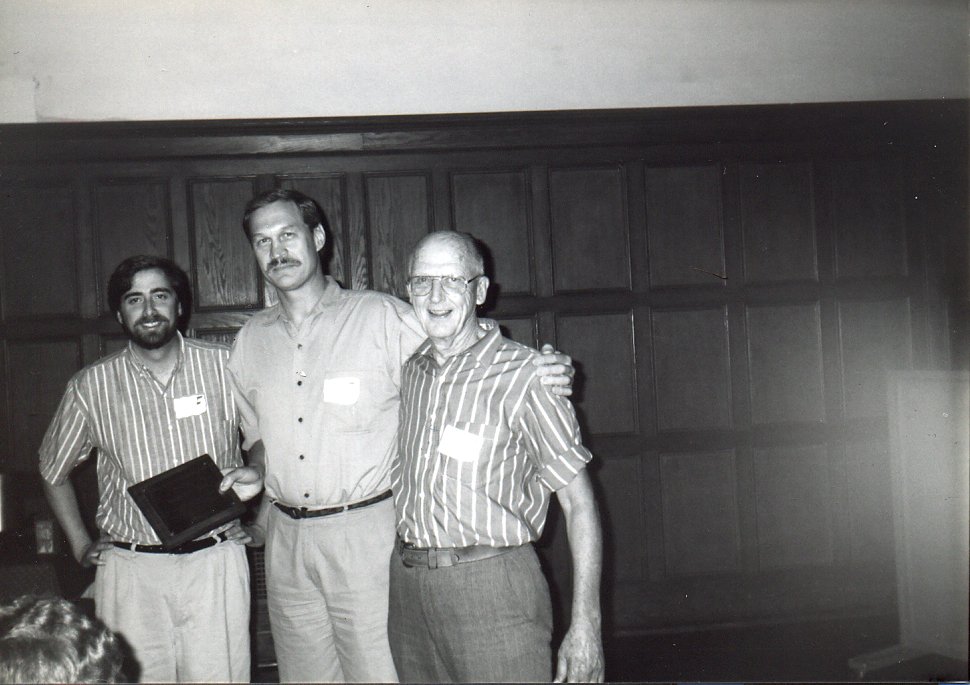 Ed Nestingen (right) at the Nestingen Symposium, 1995. The print is labeled "Nestingen Symposium 1995 - John Thompson - Ed Nestingen"; it doesn't say which of the other two men is John Thompson. Photograph from the University YMCA's files.