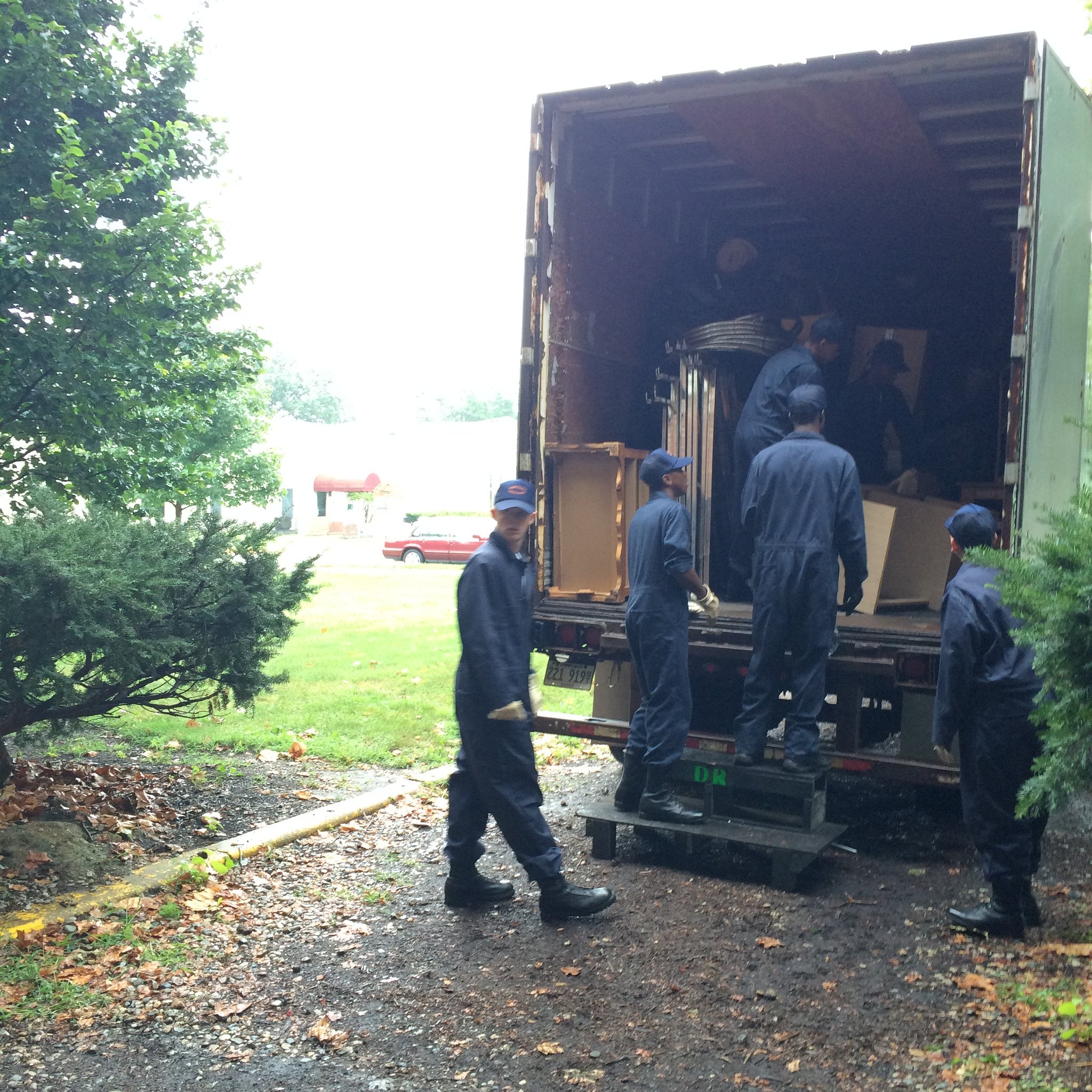 Cadets from the Lincoln's Challenge Academy in Rantoul unload furniture from a box truck at the Stock Pavilion, Aug. 18, 2015. University YMCA photograph.