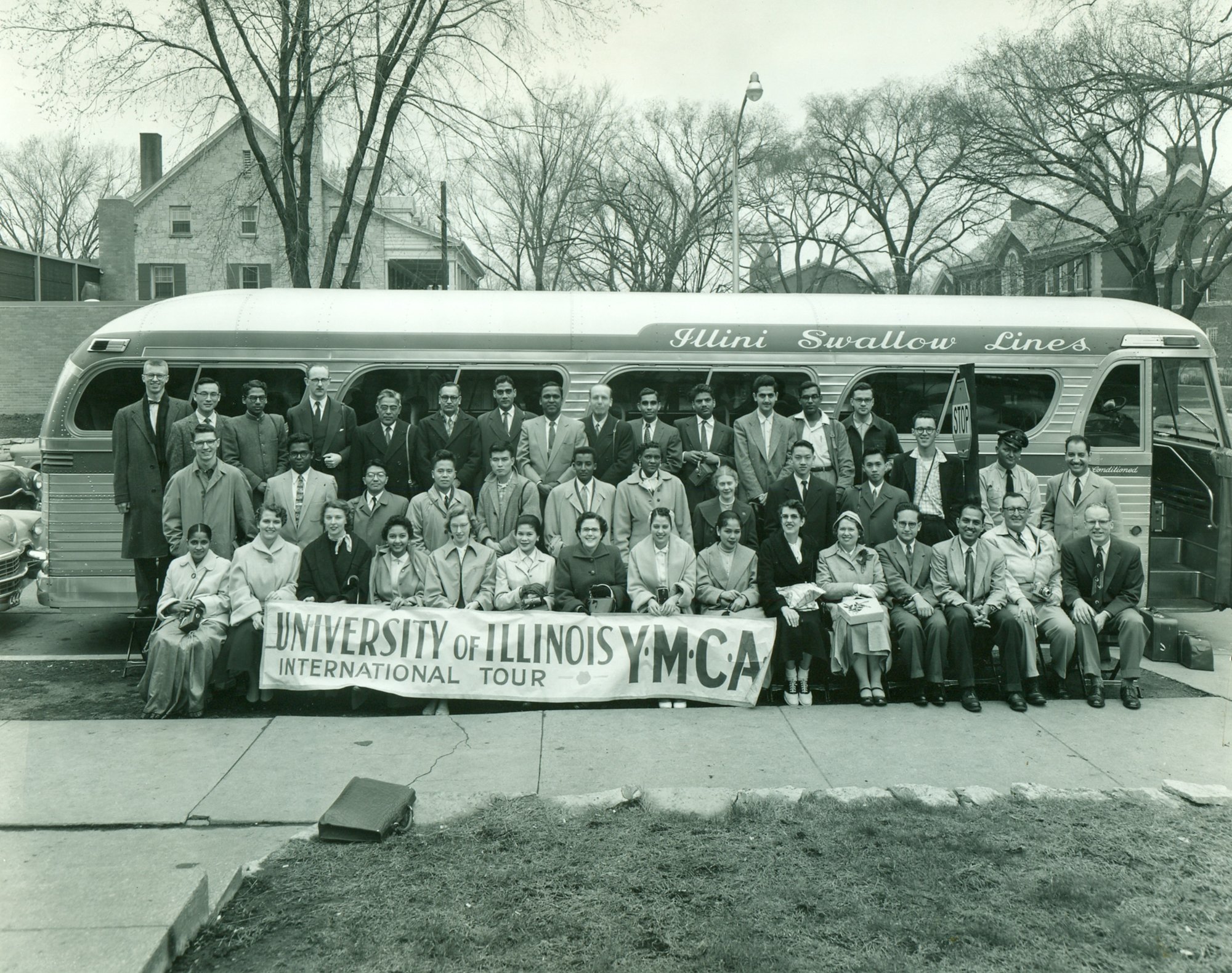 The sixth annual University of Illinois YMCA International Tour, spring 1957, before its Illini Swallow Lines bus.