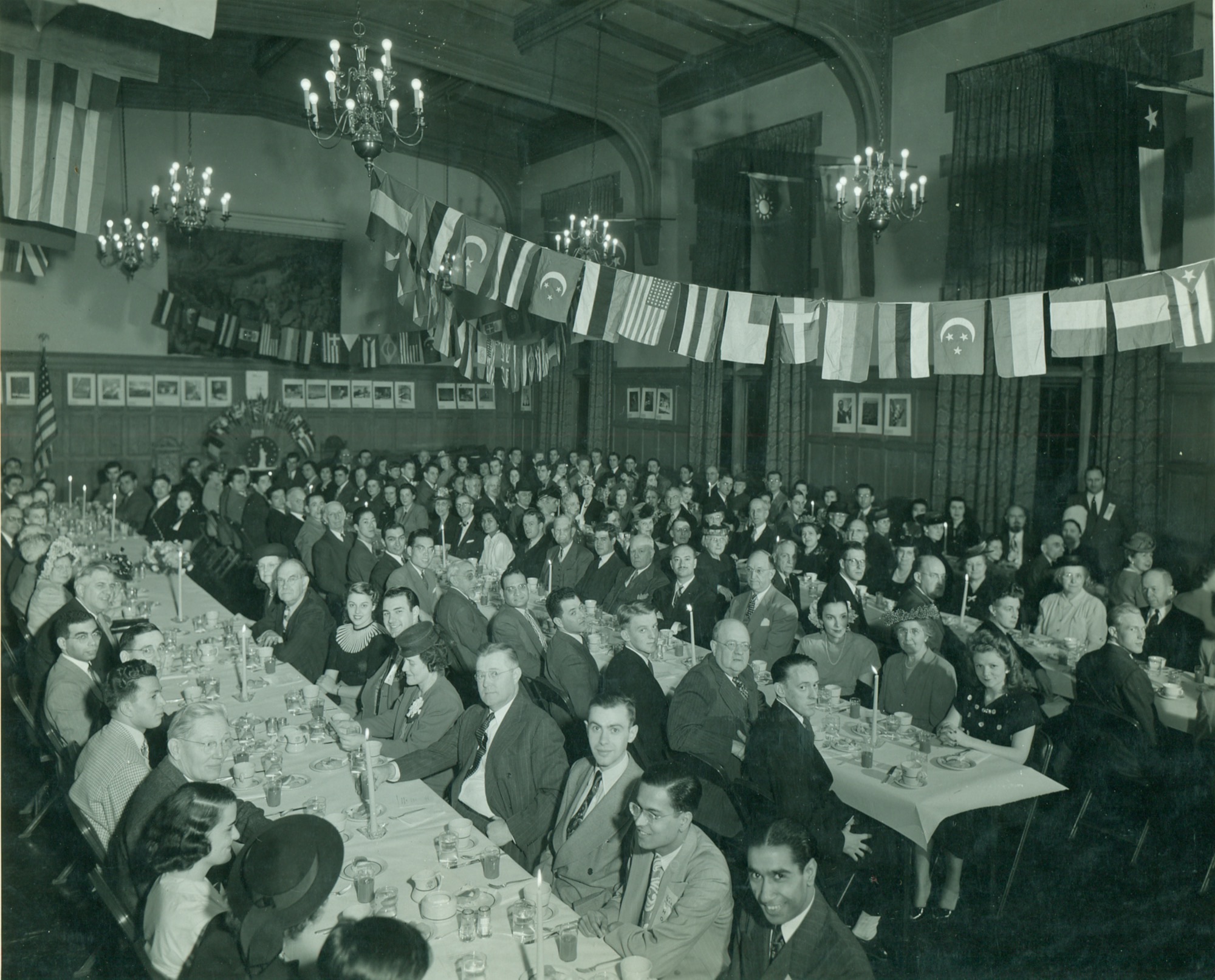 The 25th annual International Friendship Dinner in Latzer Hall, April 1, 1948, under a string of national flags. University YMCA Archives.