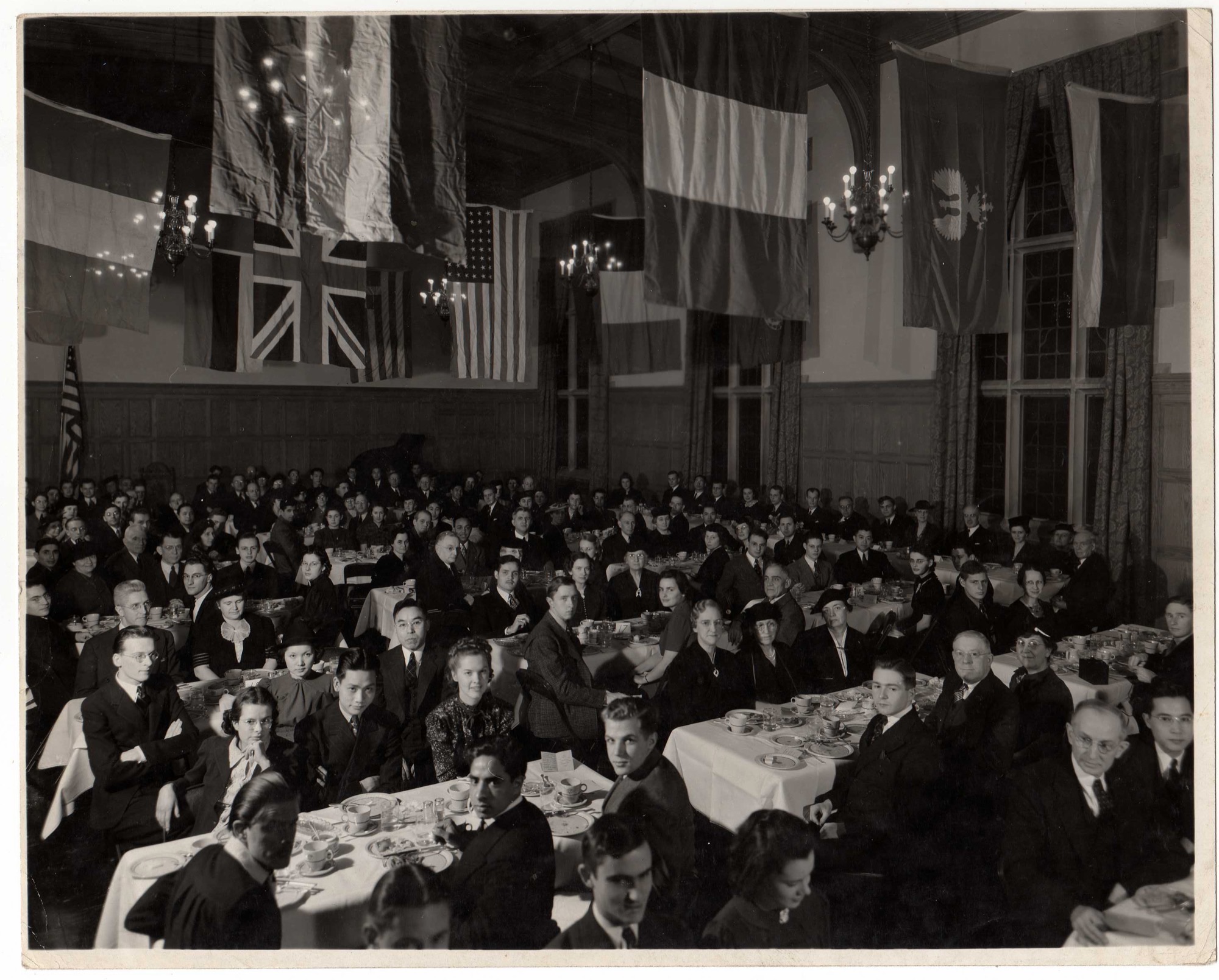An International Dinner in Latzer Hall under the flags of the guests' nations, about 1940.