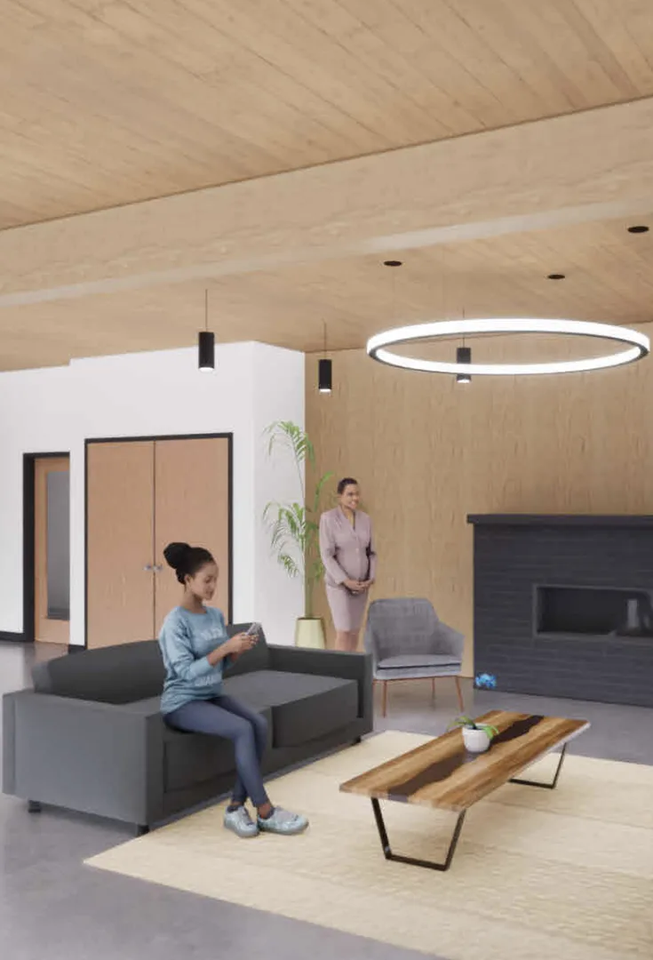 Rendering of the Woodward Lofts community room: a resident sits on a sofa by a wooden coffee table, with a fireplace and a timber ceiling.
