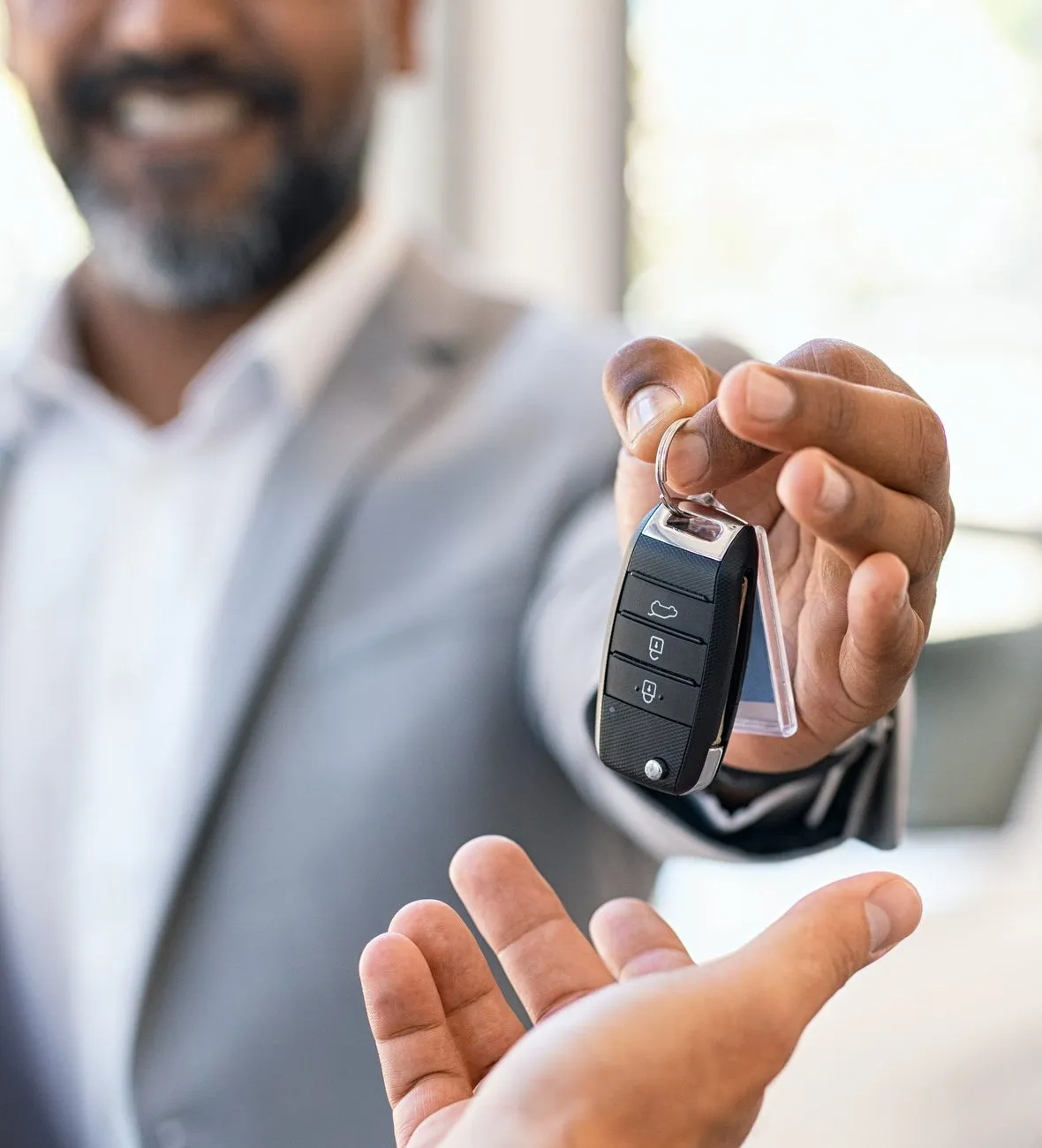 Dealer handing car keys to a customer