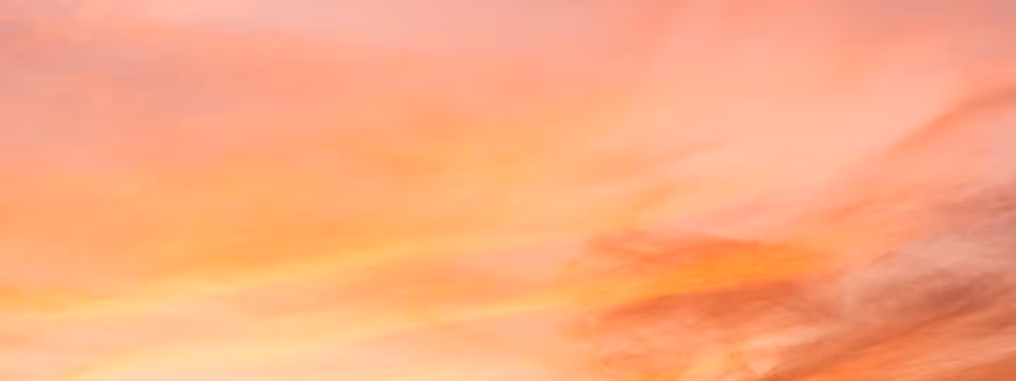 Sunset sky with soft pink and orange clouds