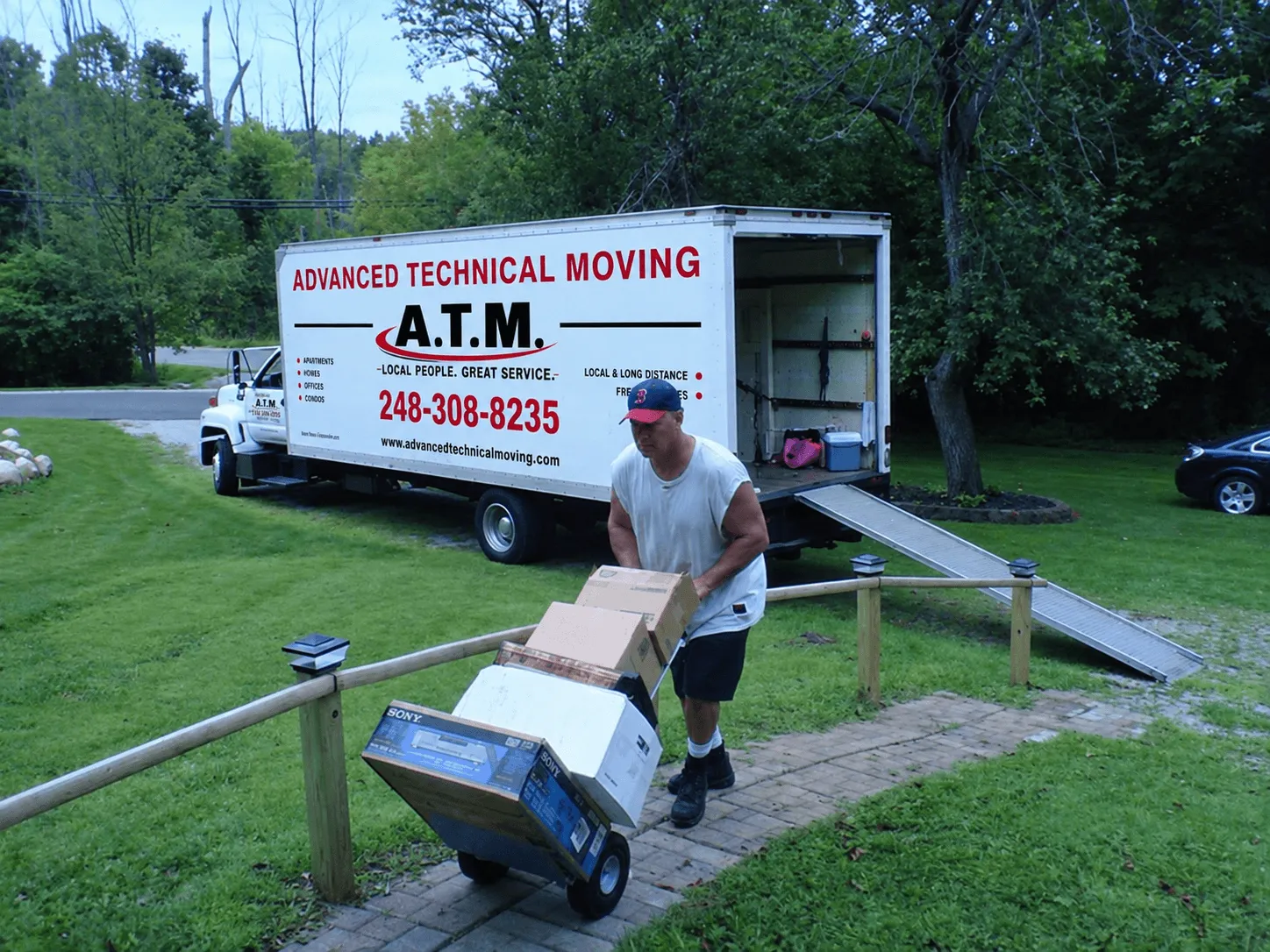Advanced Technical Moving truck parked on a suburban street outside a home during a move