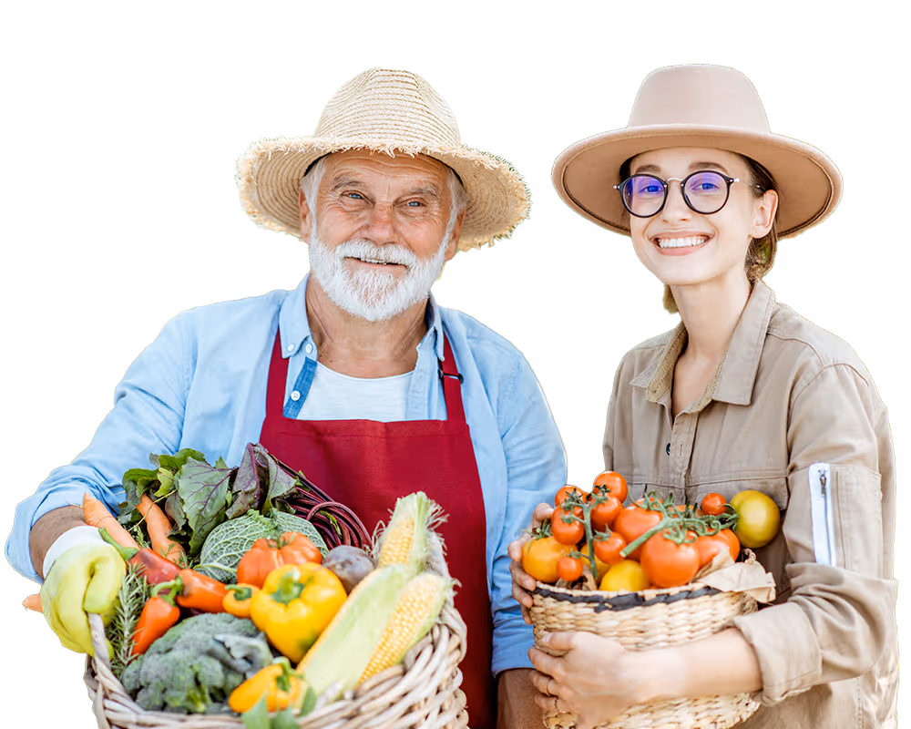 Smiling elderly man in straw hat and younger woman in beige hat holding baskets of fresh vegetables.