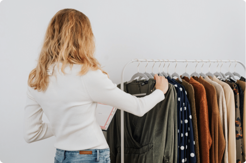 a girl going through her clothes that needs to learn Can Influencers Write Off Clothes?