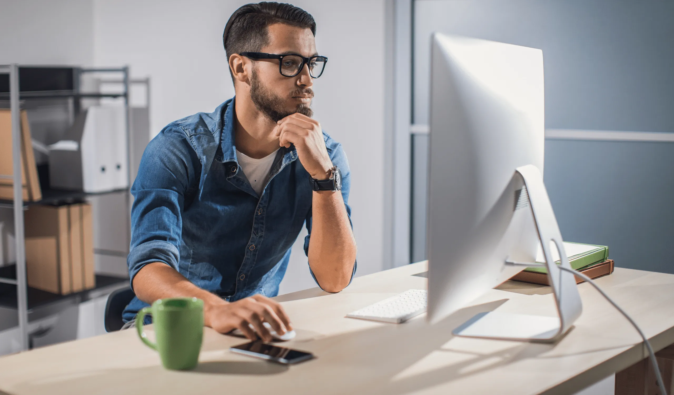 A guy using a computer to learn about tax extensions as a content creator.