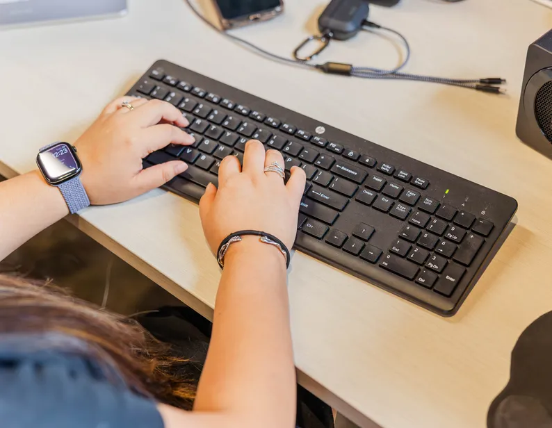 Hands typing on a keyboard