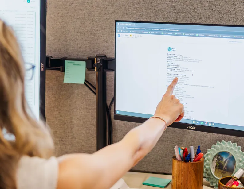 A creator pointing at a screen that shows YouTube income