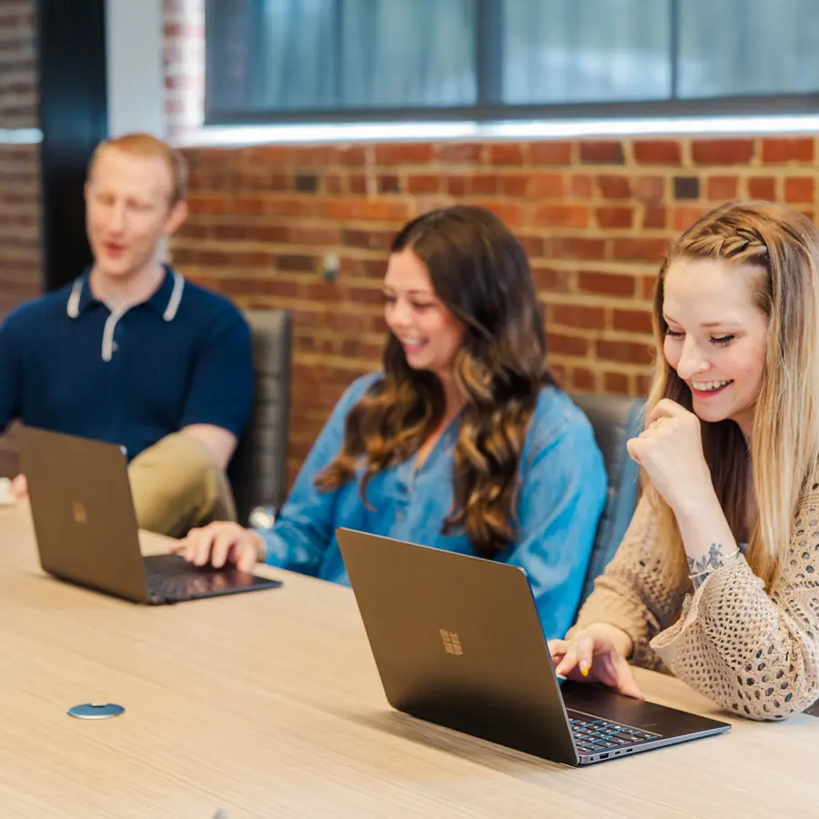 Colleagues working together at their desks in the Cookie Finance office