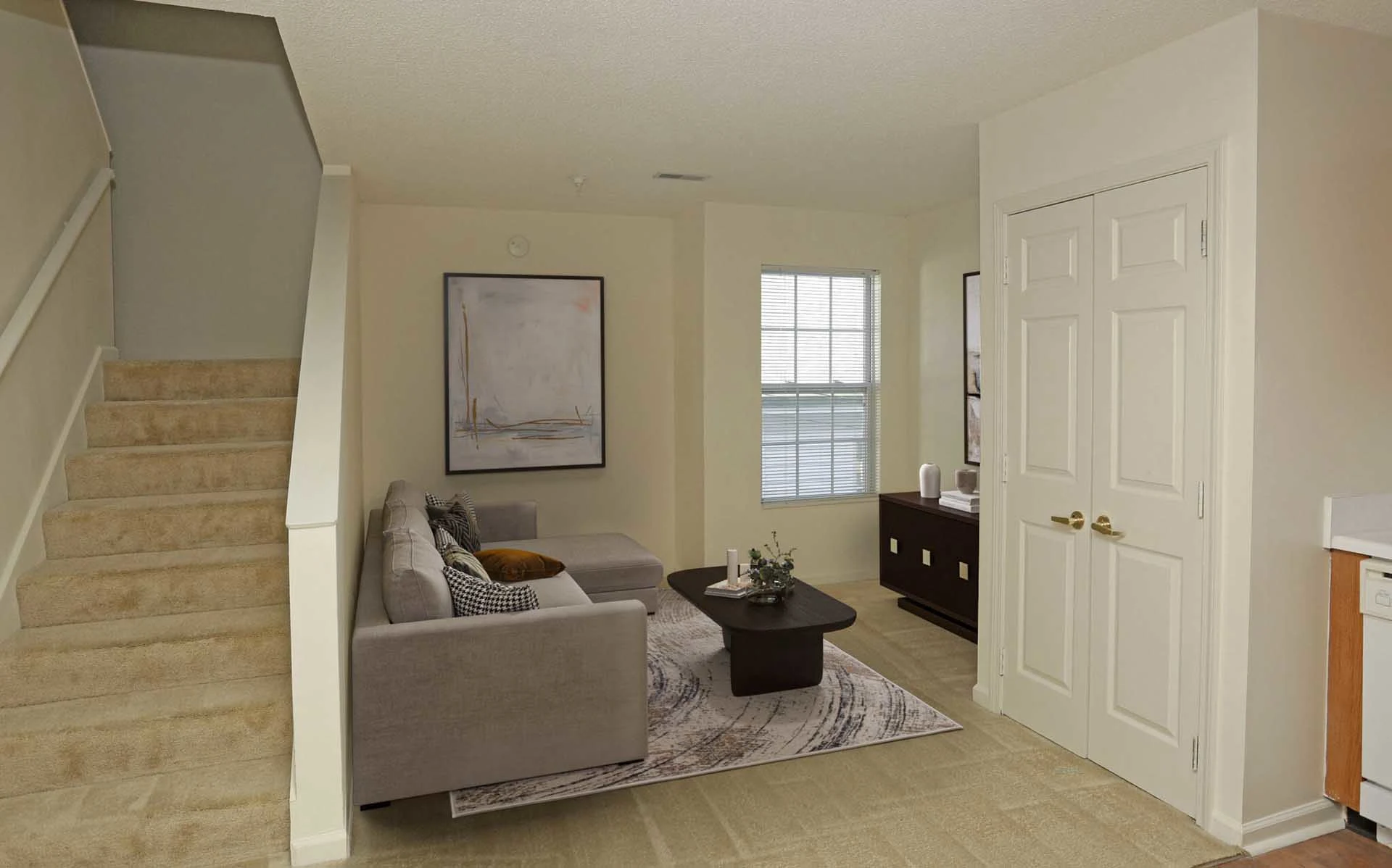 Furnished living room with staircases
