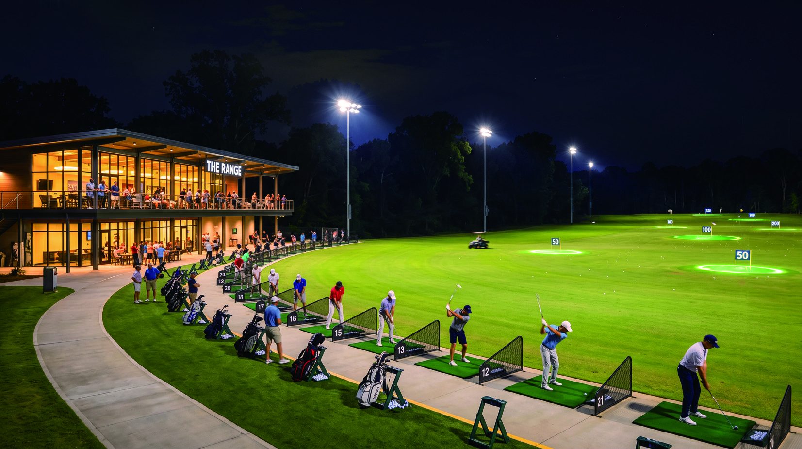 Driving range hitting bays lit at night