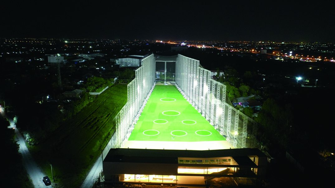 Golf range facility with netting lit at night