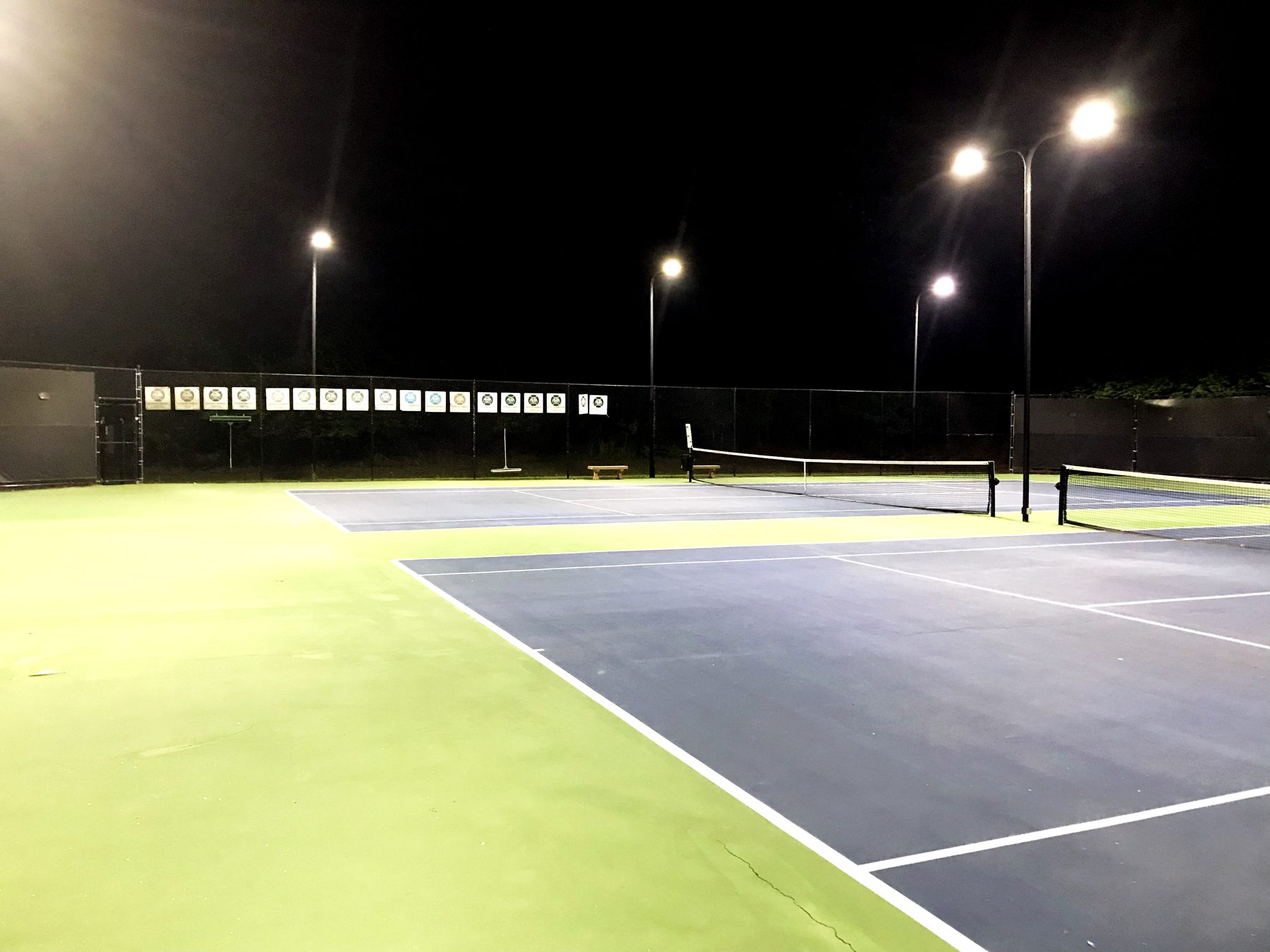 Princeton Square tennis courts lit at night