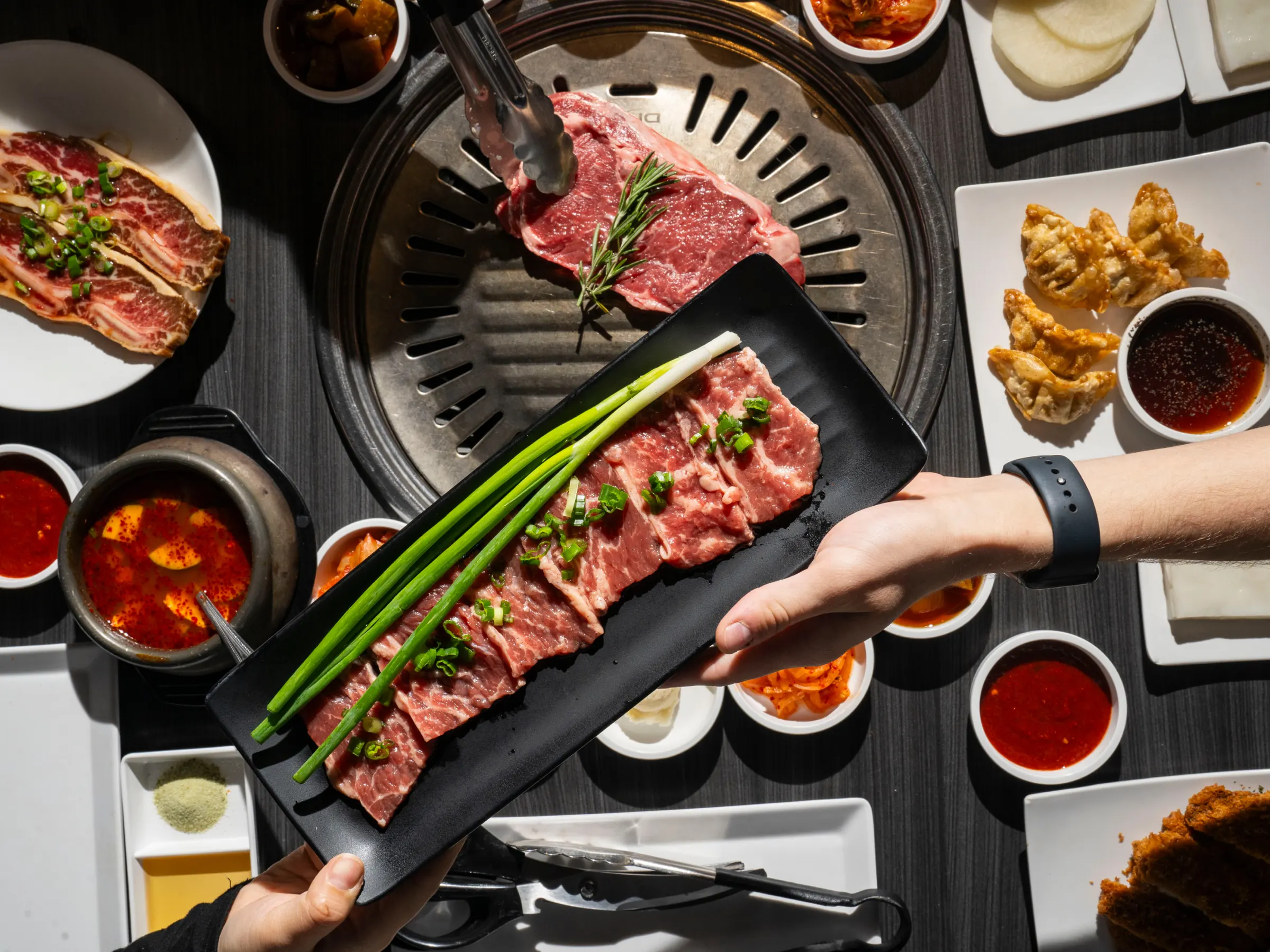 A plate of sliced beef passed over the GEN grill