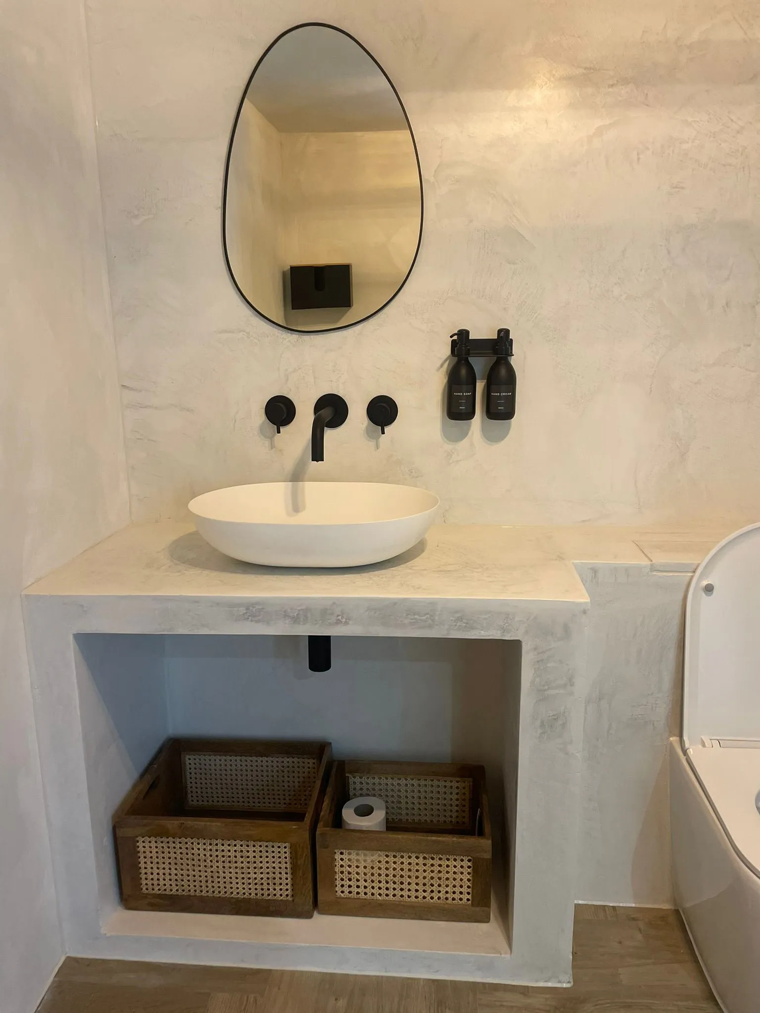 Bathroom vanity with basin and decorative wall finish