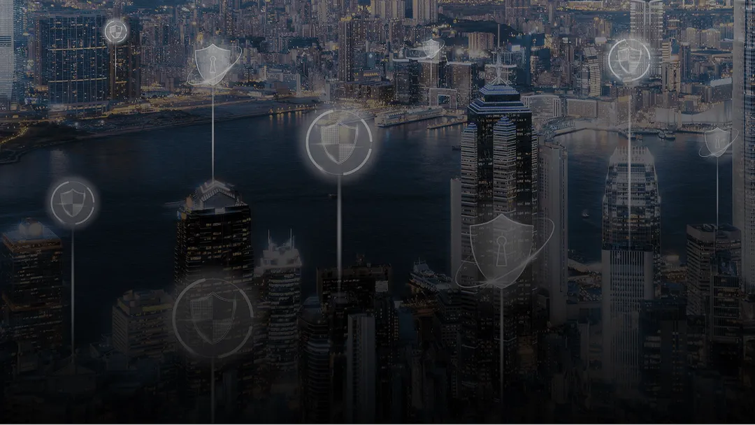 Night cityscape with illuminated skyscrapers over a river, overlaid with transparent security shield icons.