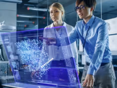Two professionals analyzing a futuristic holographic data projection in a modern office.