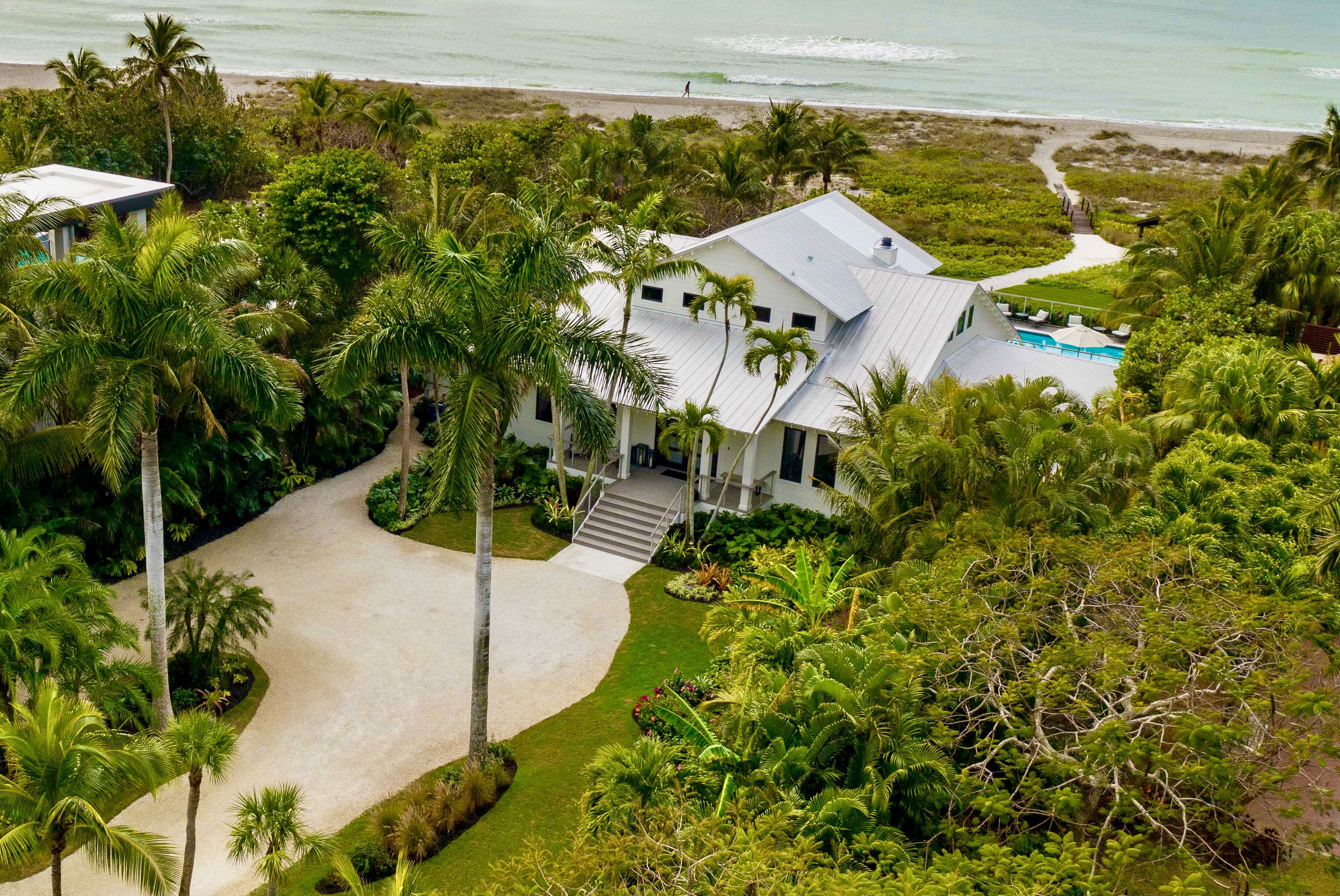 Aerial view of White Orchid among the palms, with the Gulf beach beyond