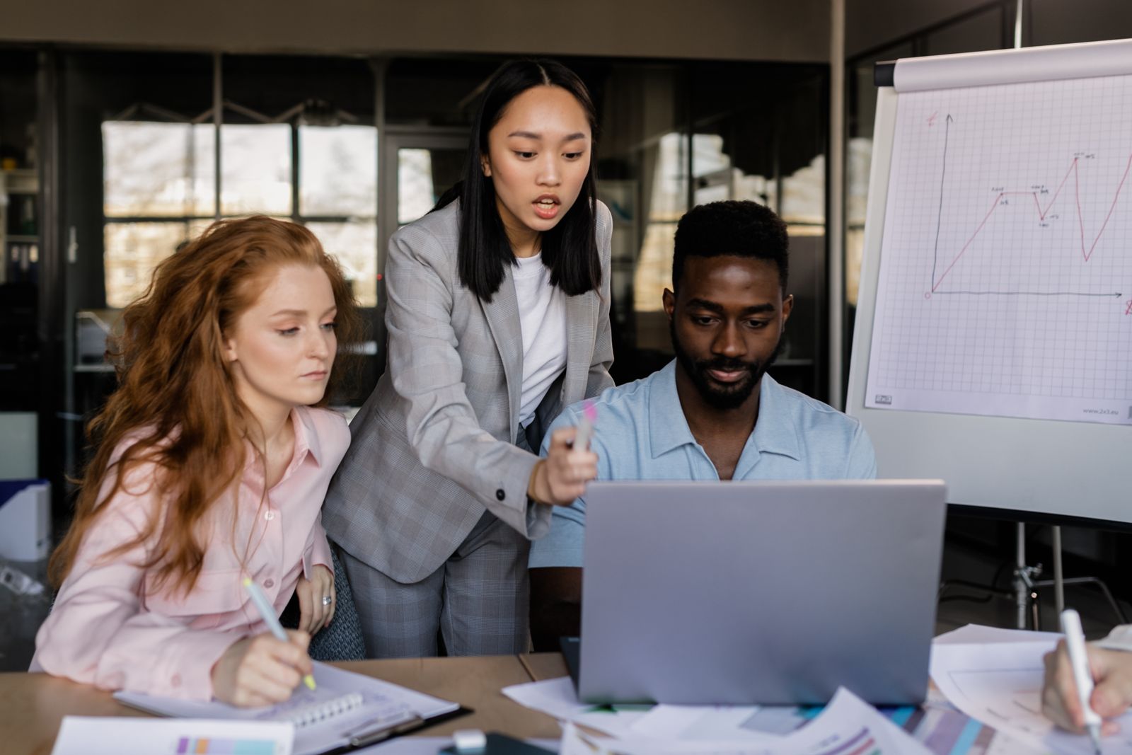 A business team discussing a shared strategy in a modern office