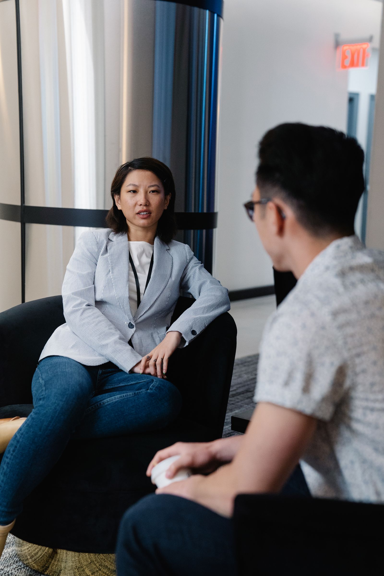Two colleagues having a professional conversation in an office