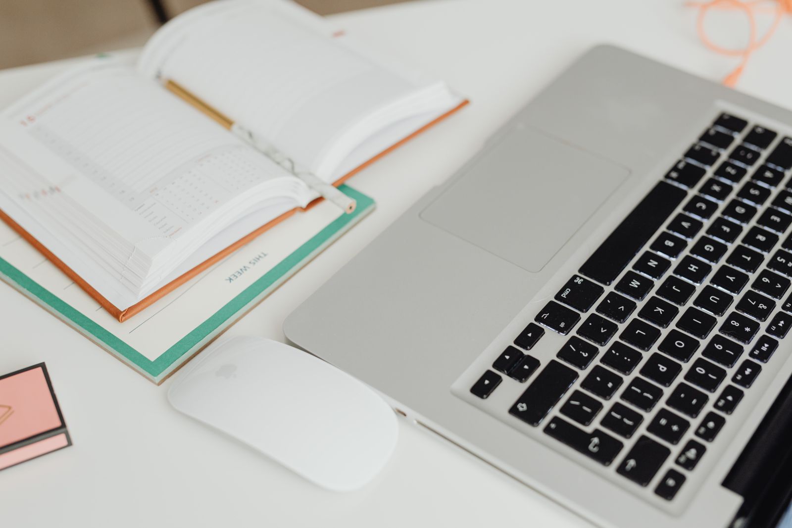 Laptop, notebook, and calendar on a tidy workspace
