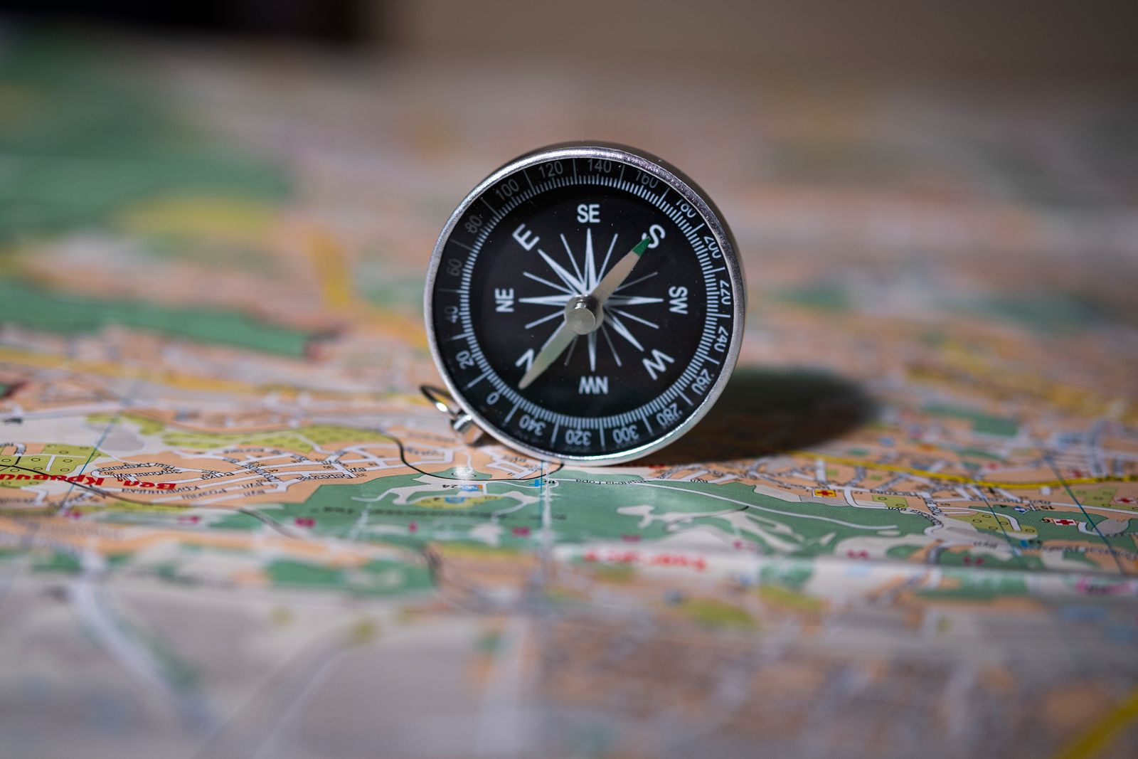 Compass resting on a map