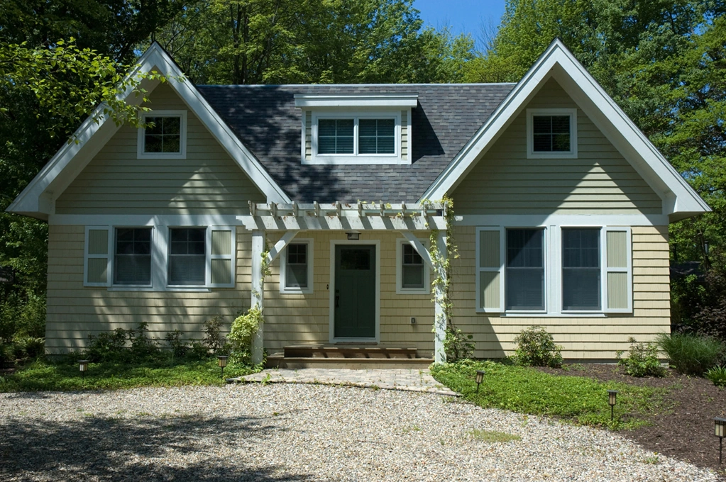 CC2 house with twin gables and a white pergola over the entrance