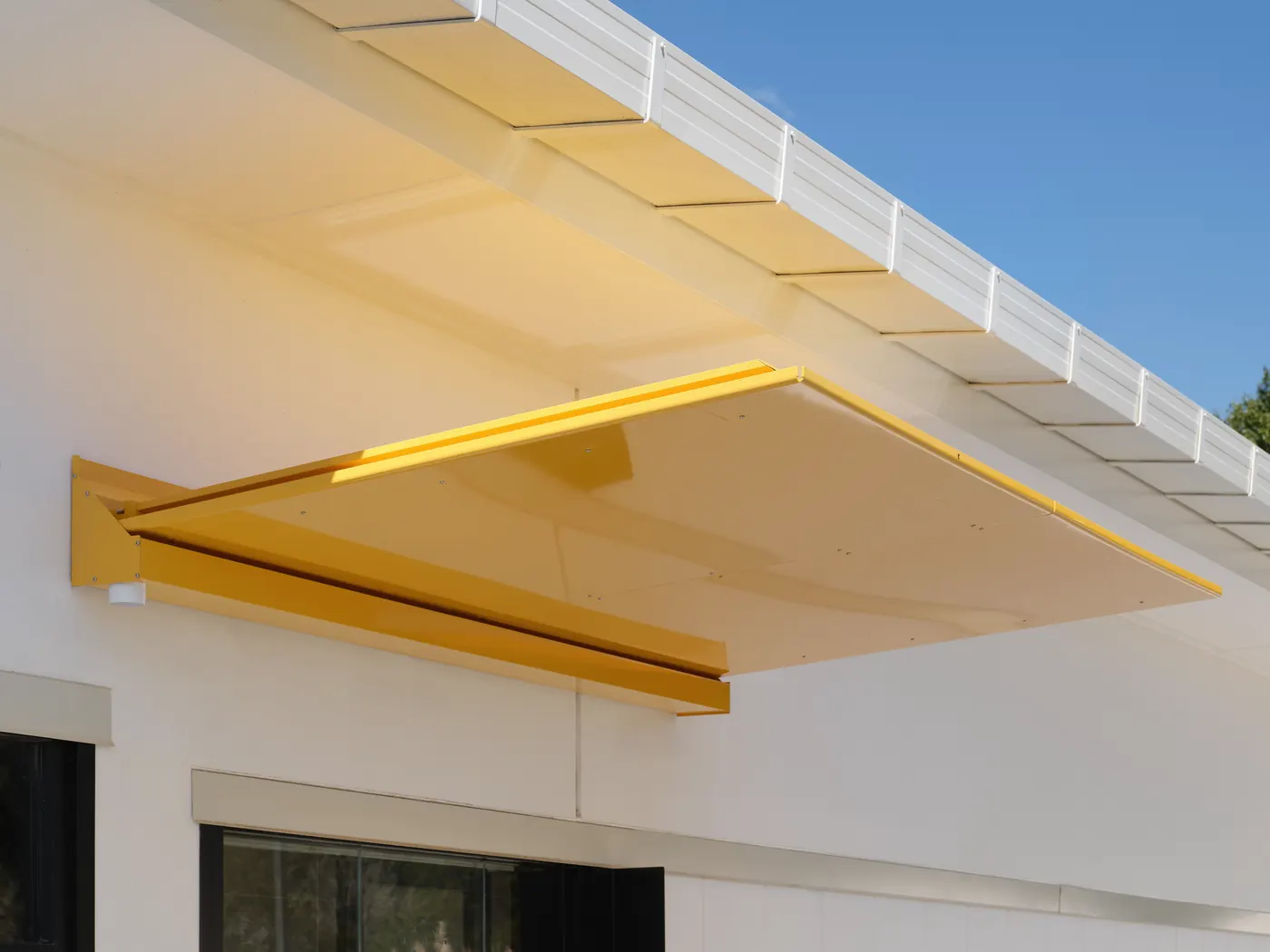 A yellow Equinox canopy on its outriggers, McDonald's Dairy Flat