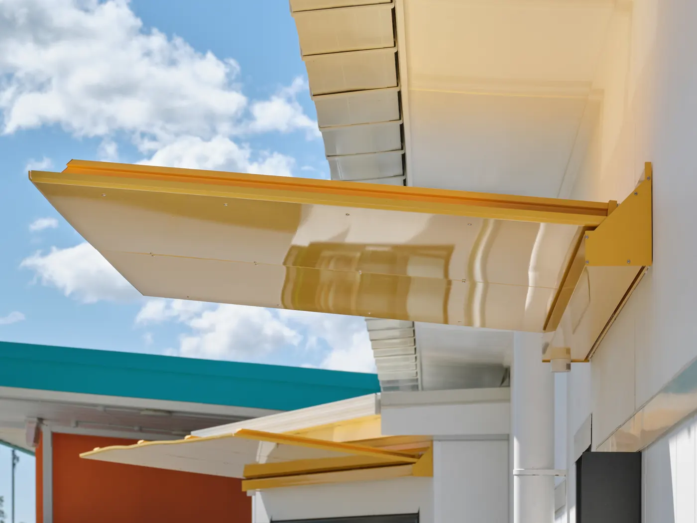 A yellow canopy against the sky, with a second canopy beyond it