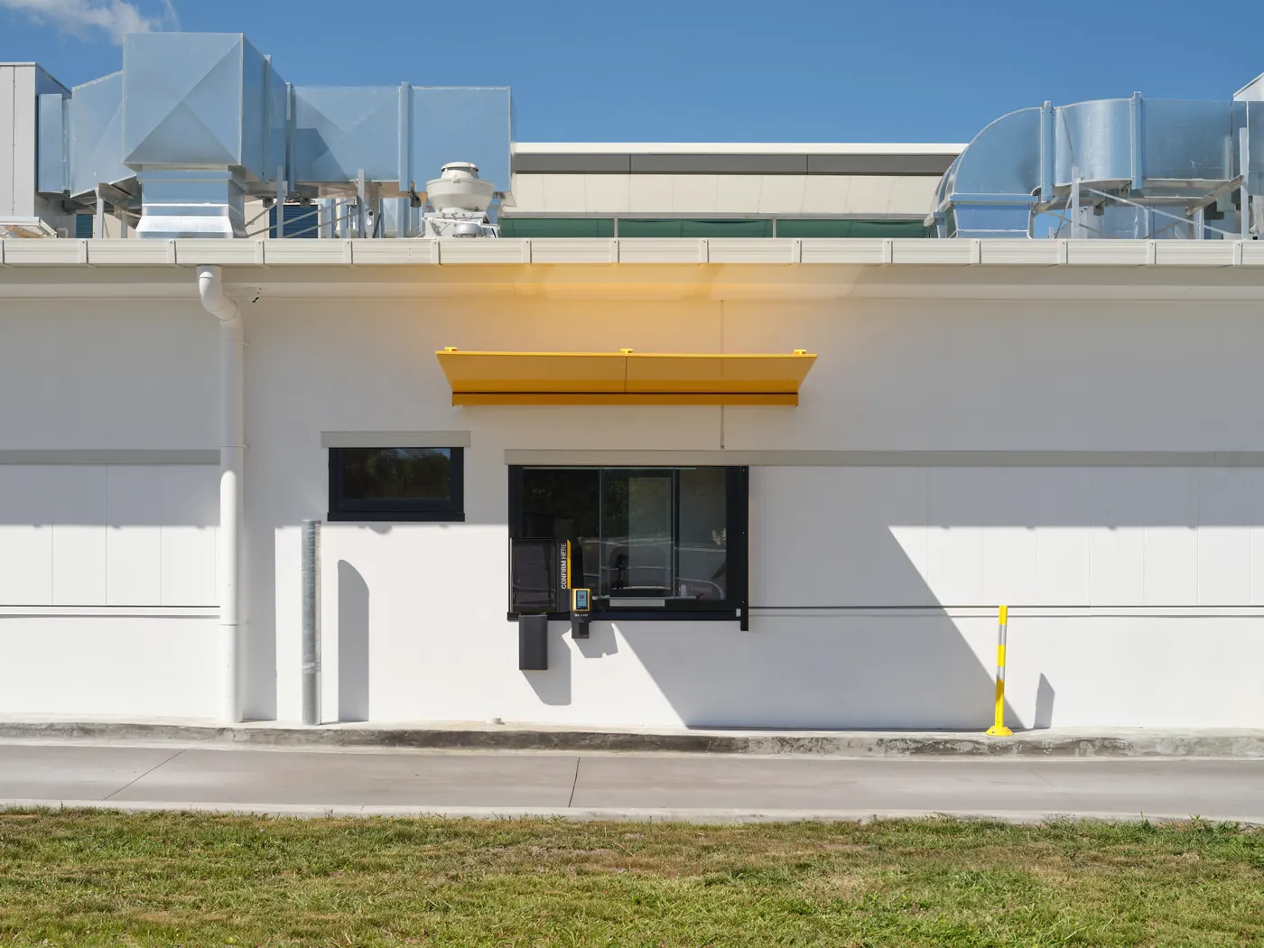 A yellow canopy over a drive-through window