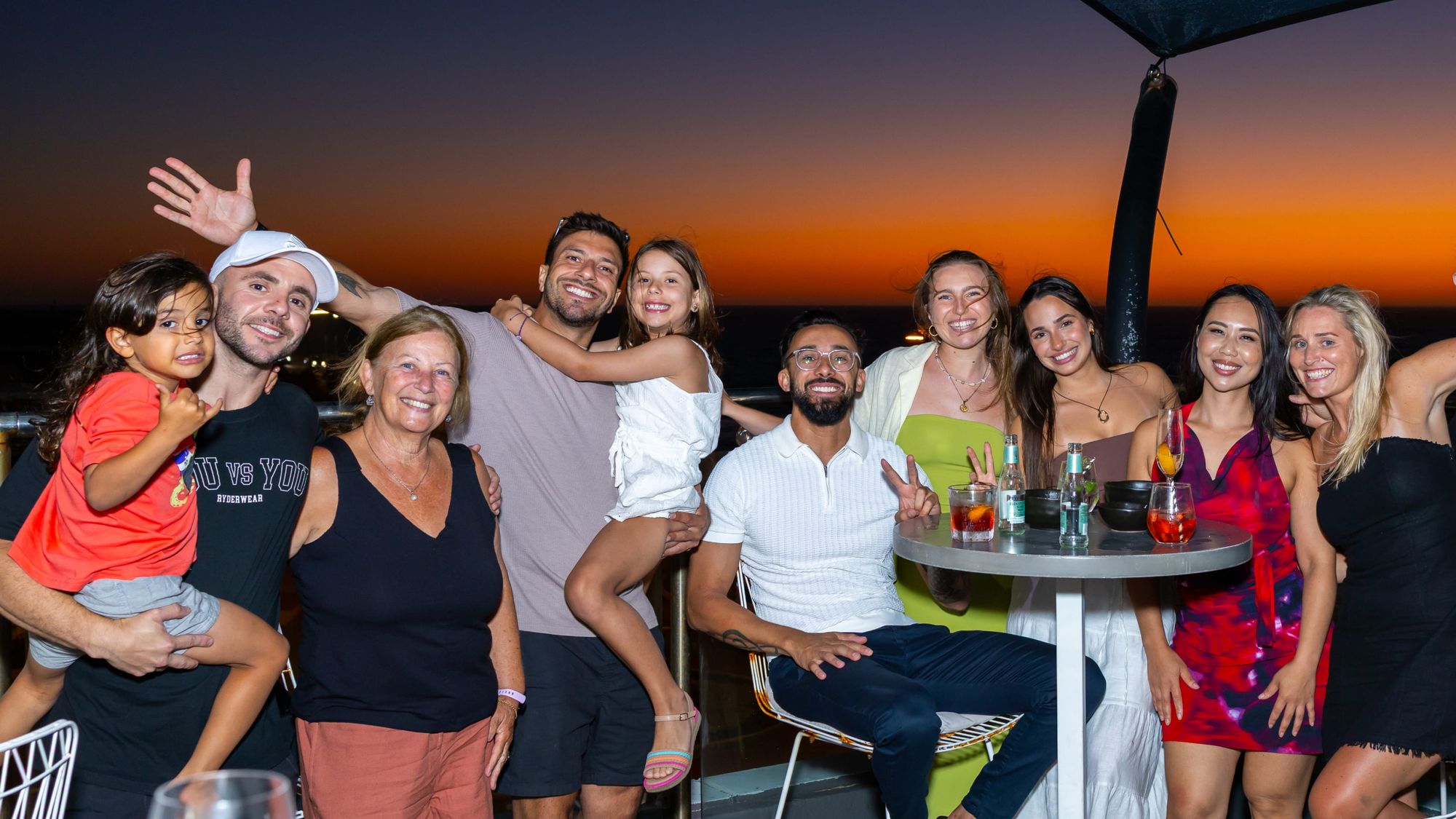 Guests gathered for an event on the ocean-view terrace at sunset