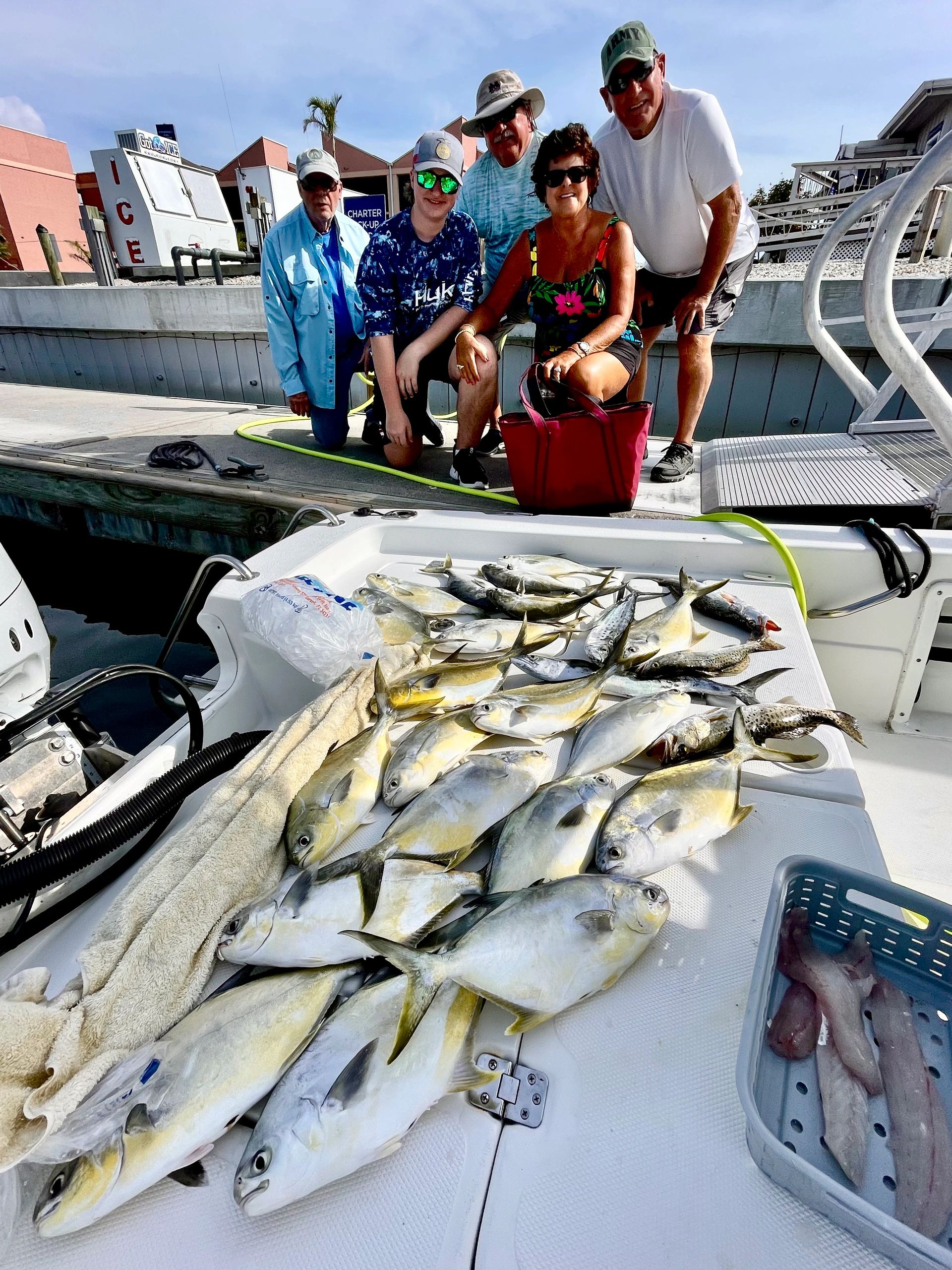 Group at the dock with a catch of pompano from an inshore charter