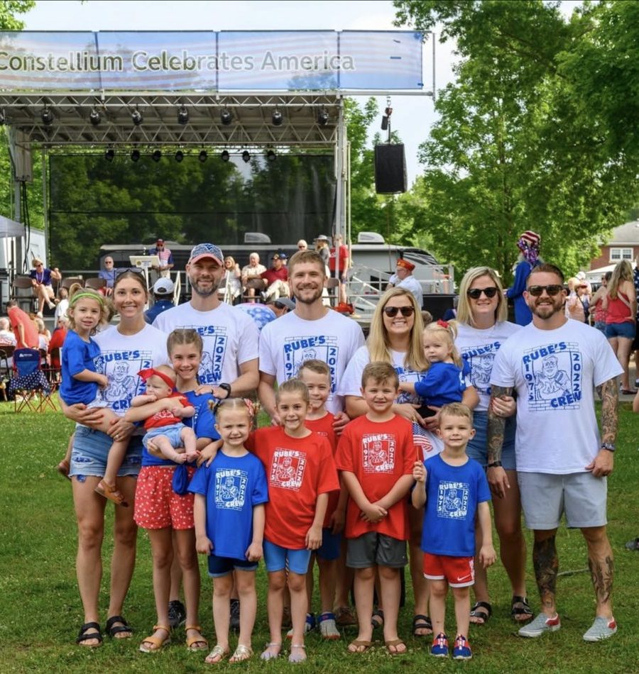 Families in matching event shirts at a Constellium celebration