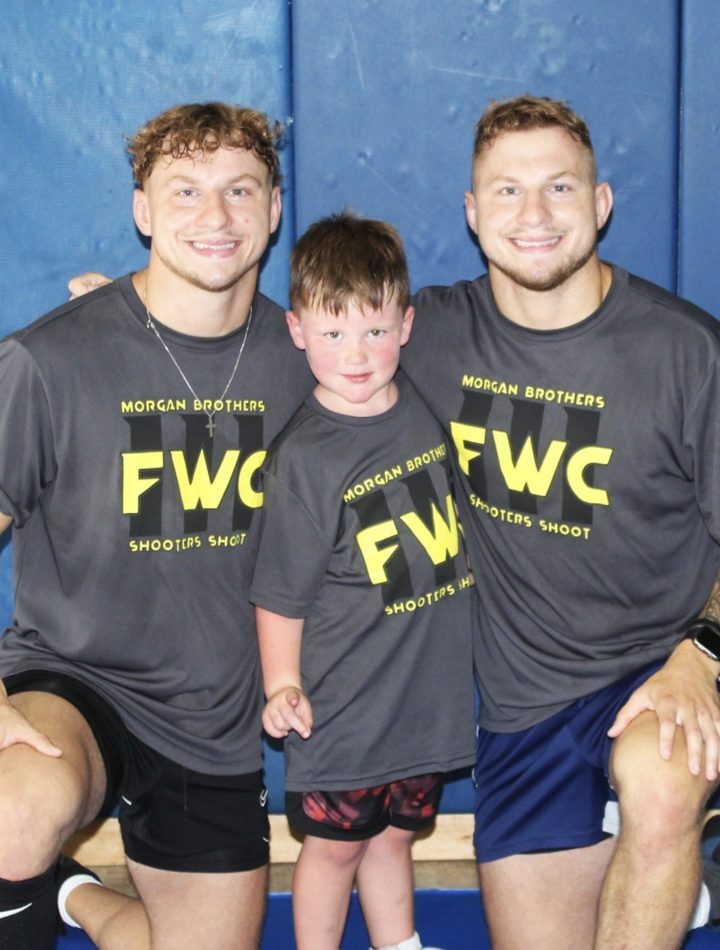 Two athletes and a boy in matching FWC shirts