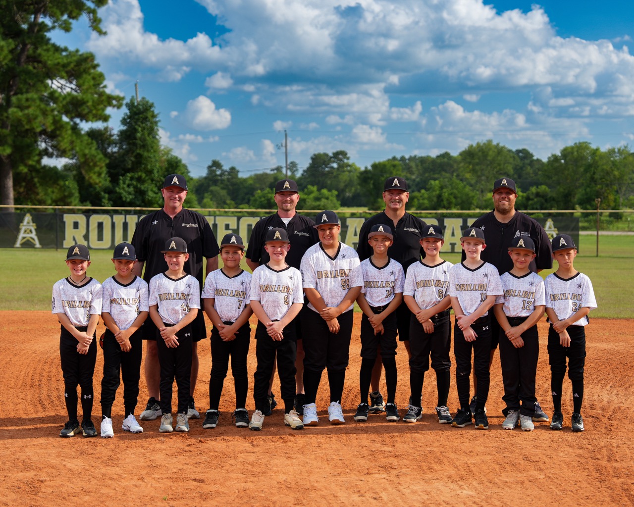 DrillBit Roughnecks 10U Sadler team photo with coaches on the field