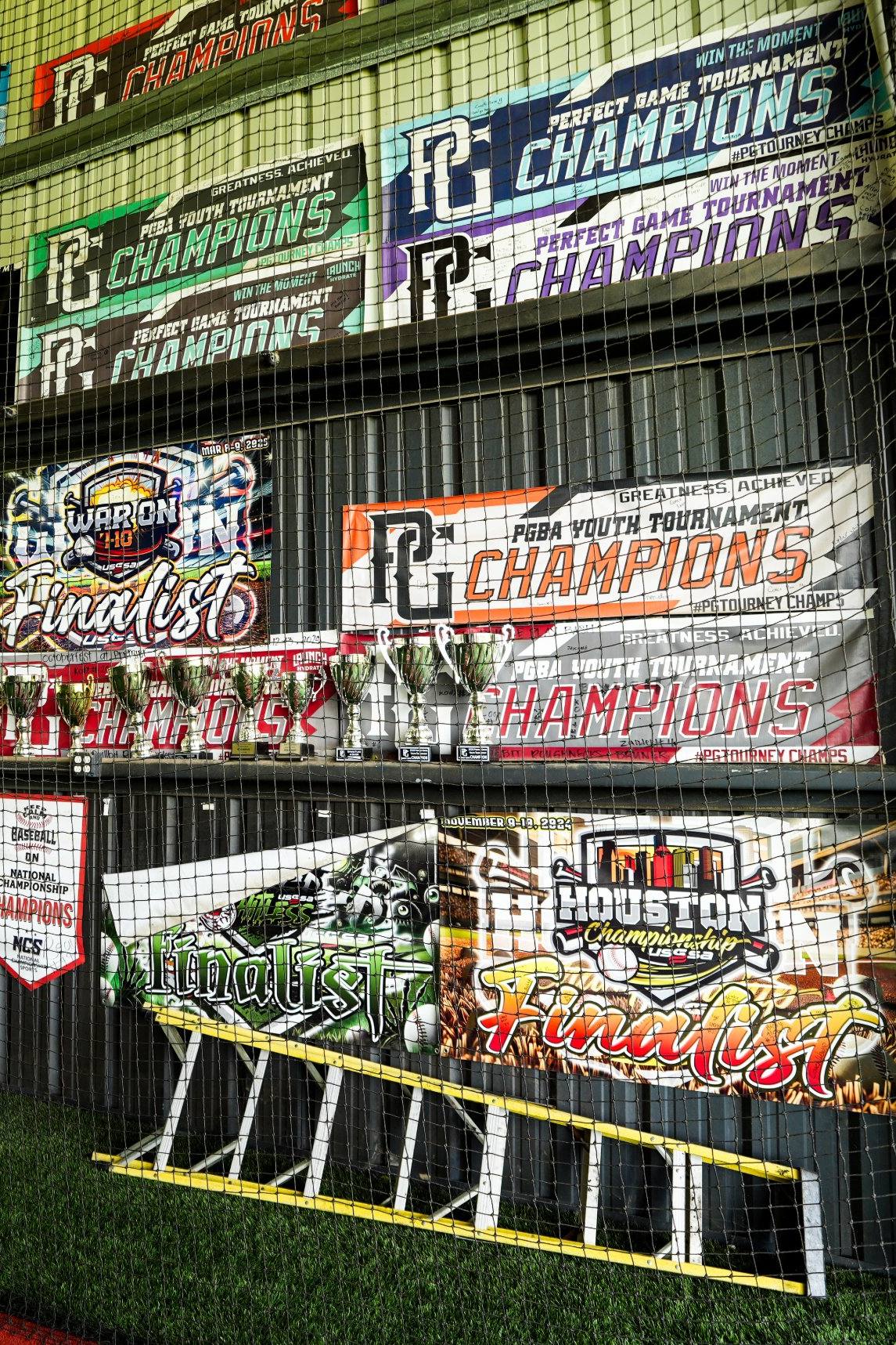 Wall of championship banners inside the DrillBit facility