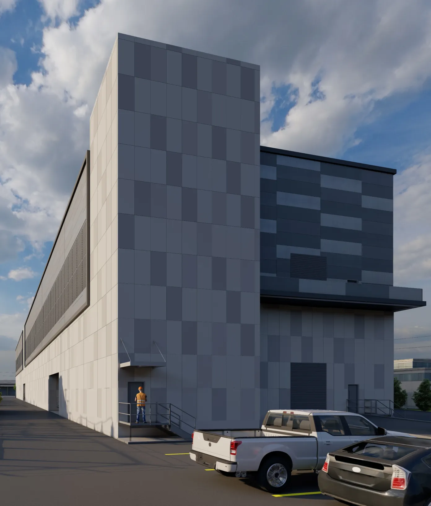 Exterior view of a modern industrial or commercial building with a gray paneled facade, two parked vehicles, and a person in a safety vest and helmet standing near a small door with metal railings under a canopy.