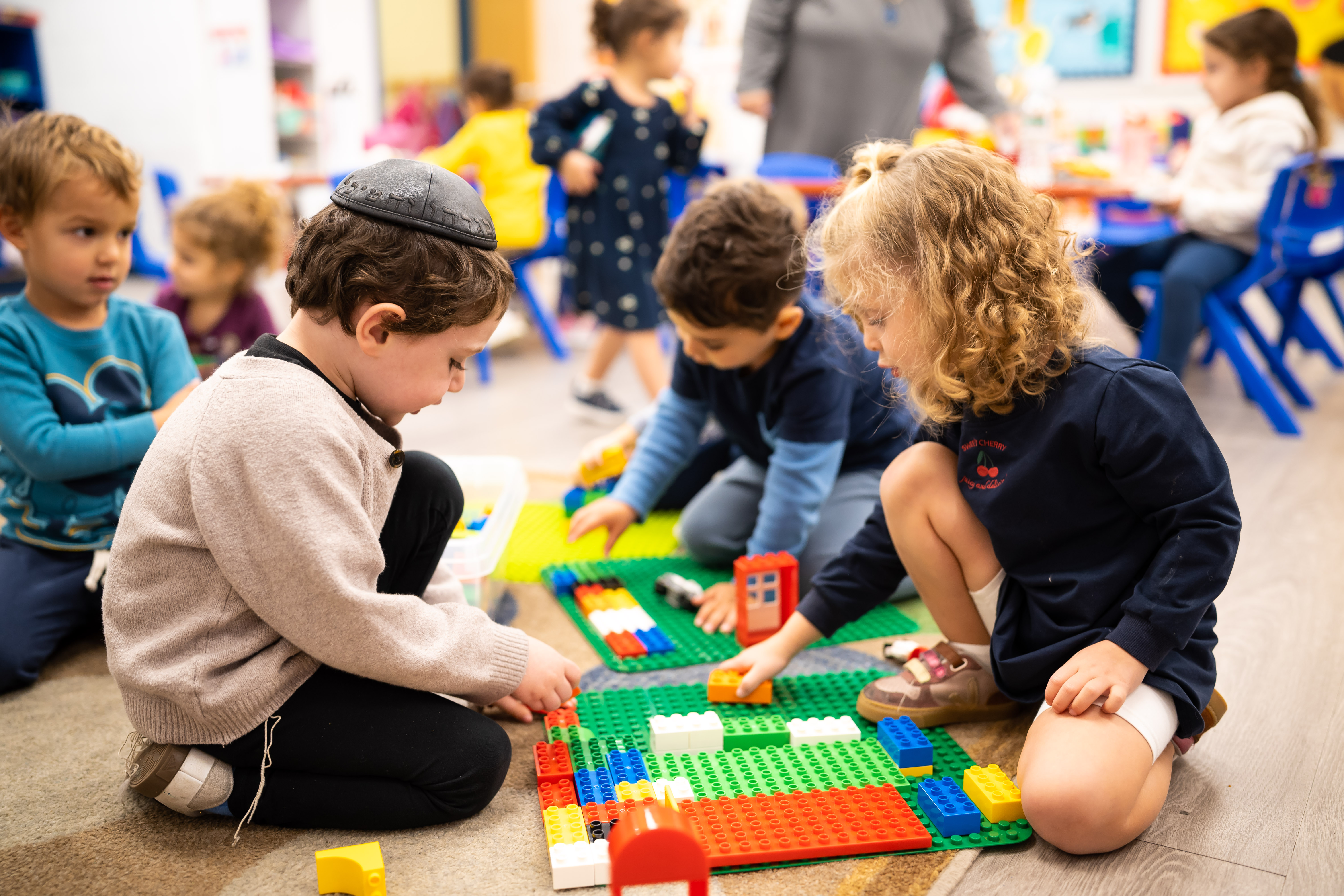 Children building with Lego bricks