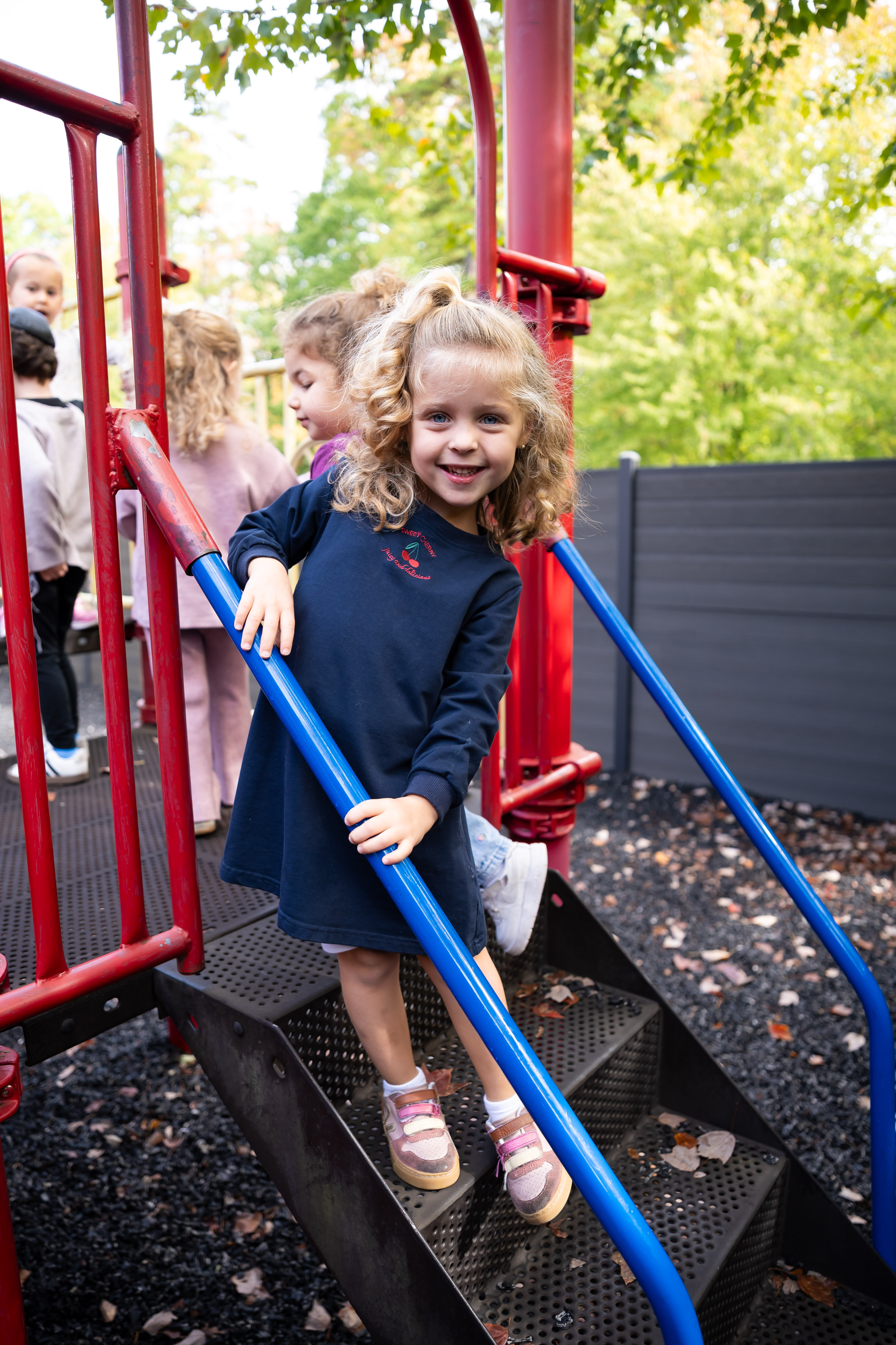 Smiling girl climbing on the playground