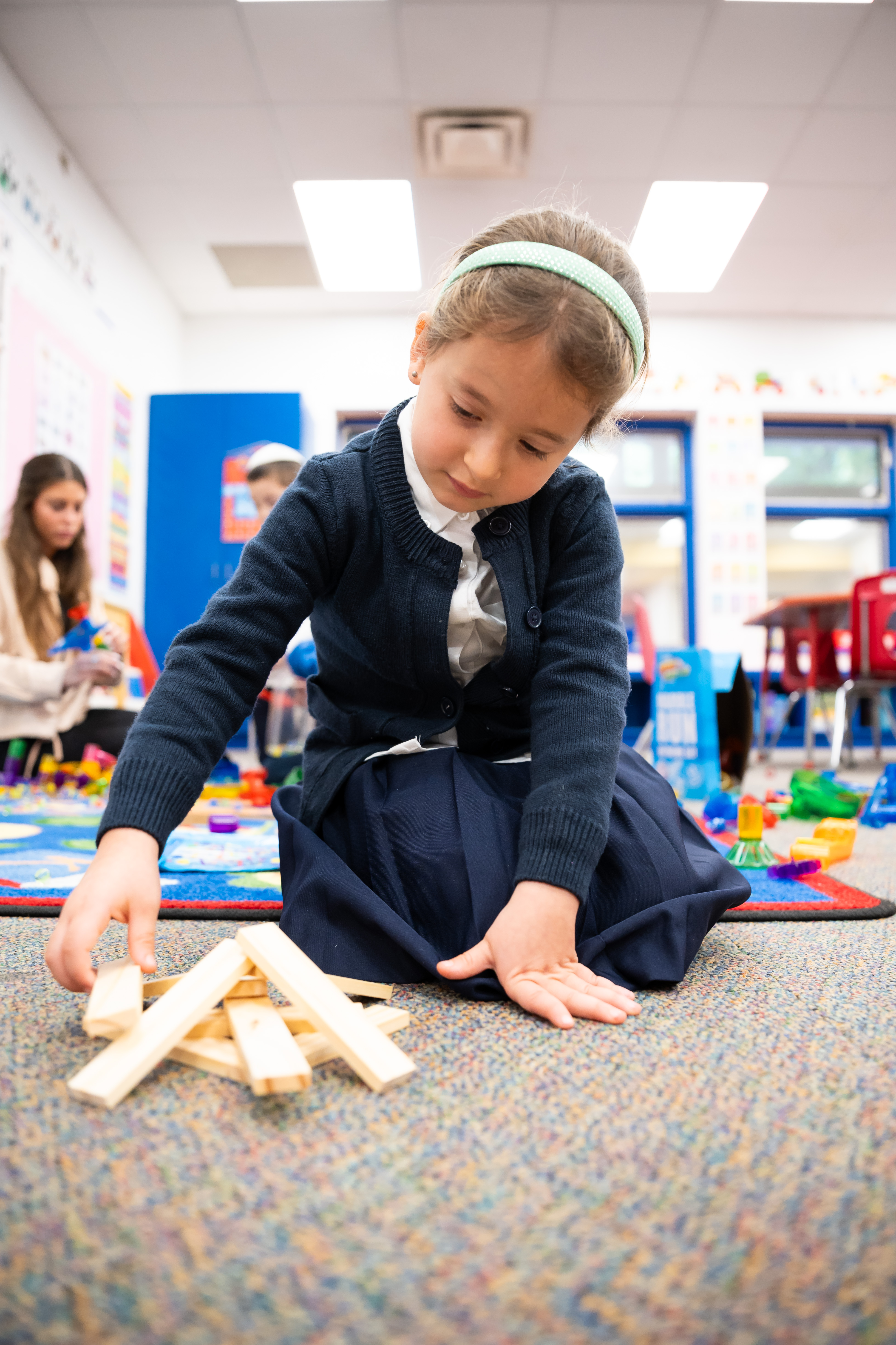 Nursery student building with wooden blocks