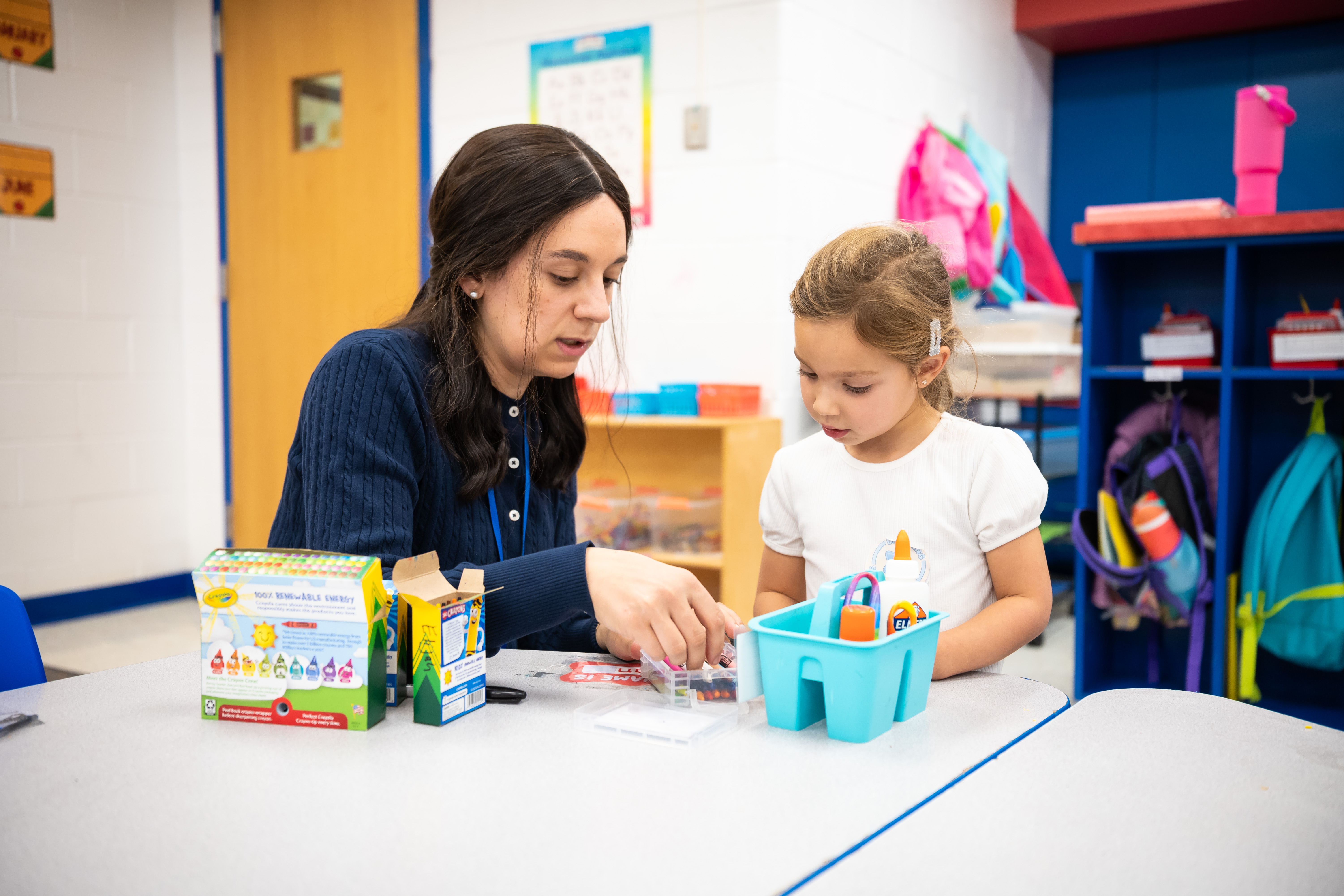 Teacher working with a child at a learning center