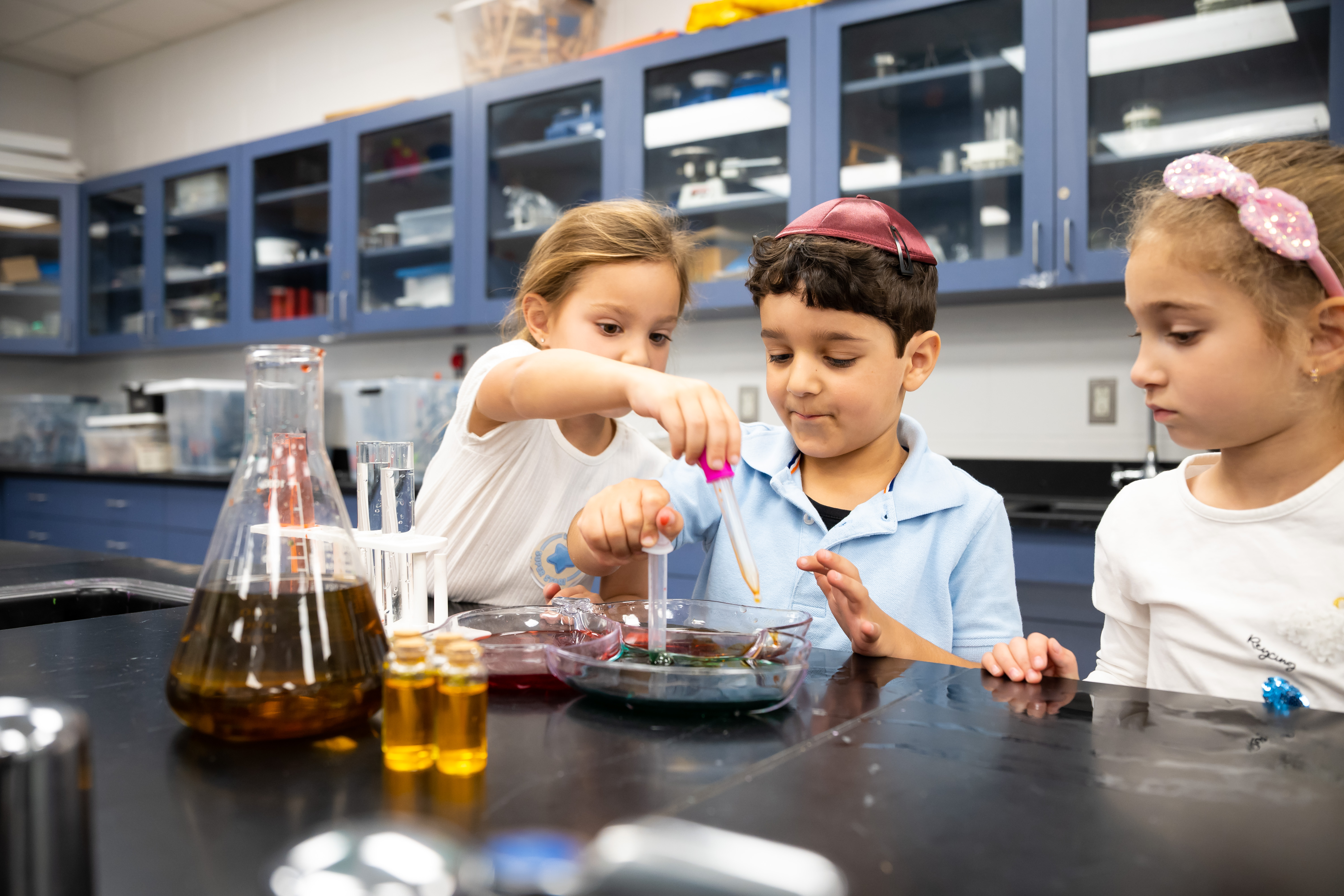Students pouring and measuring in a science activity