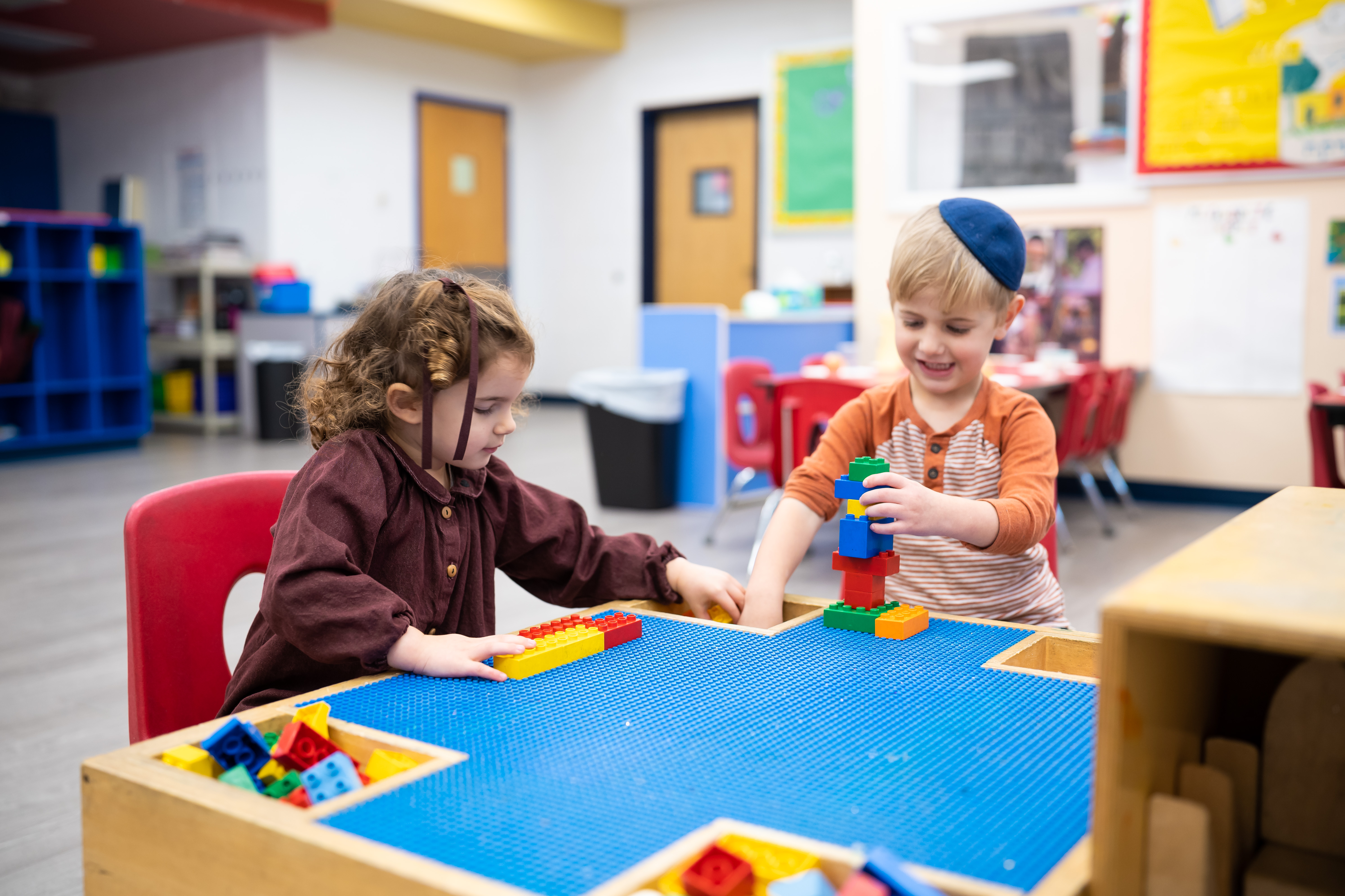 Children building with colorful blocks