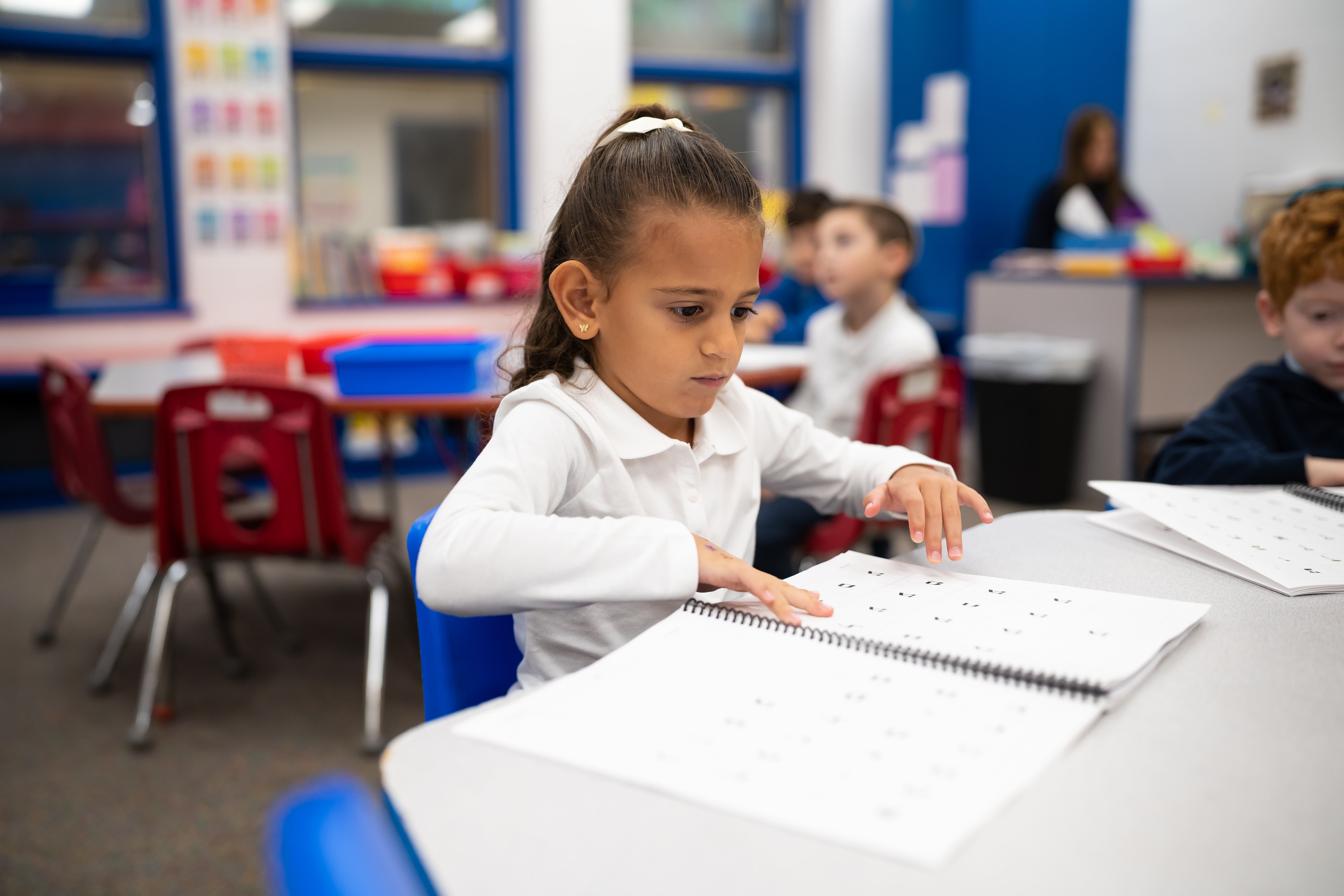 Pre-K student practicing writing