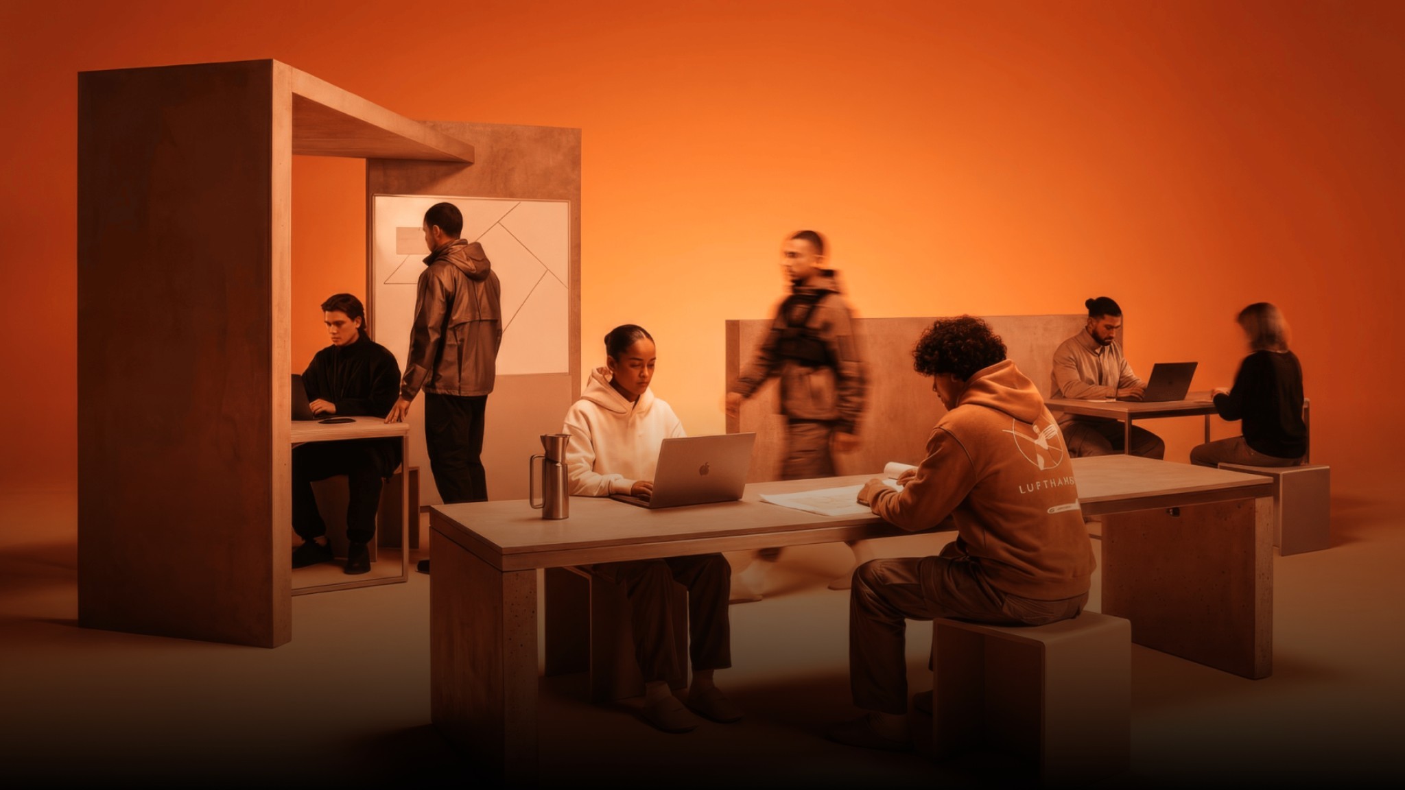Team arbeitet in einem orange beleuchteten Büro, Bildwelt von Bárries