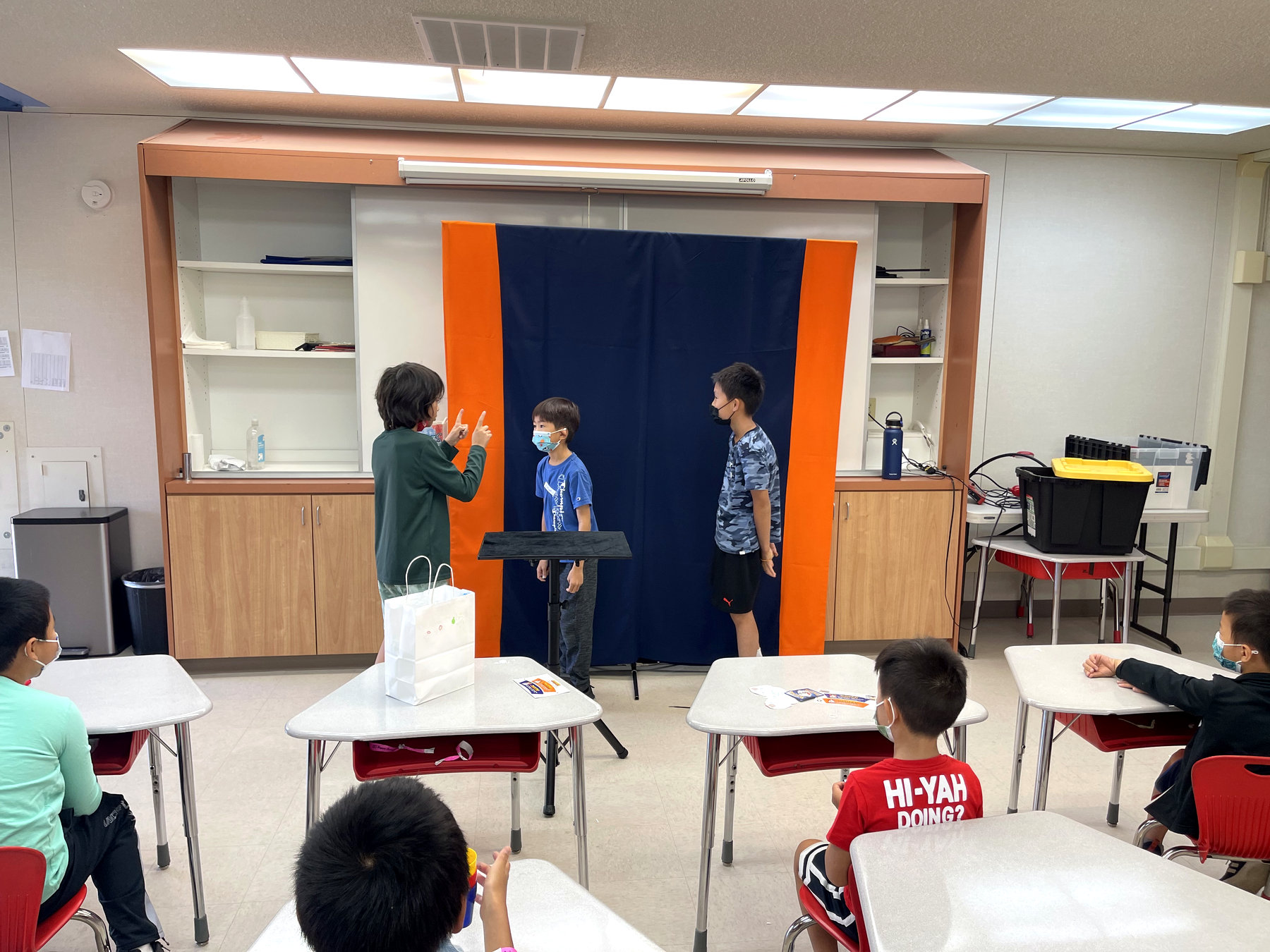 Children performing a magic trick for their classmates at the end of a class