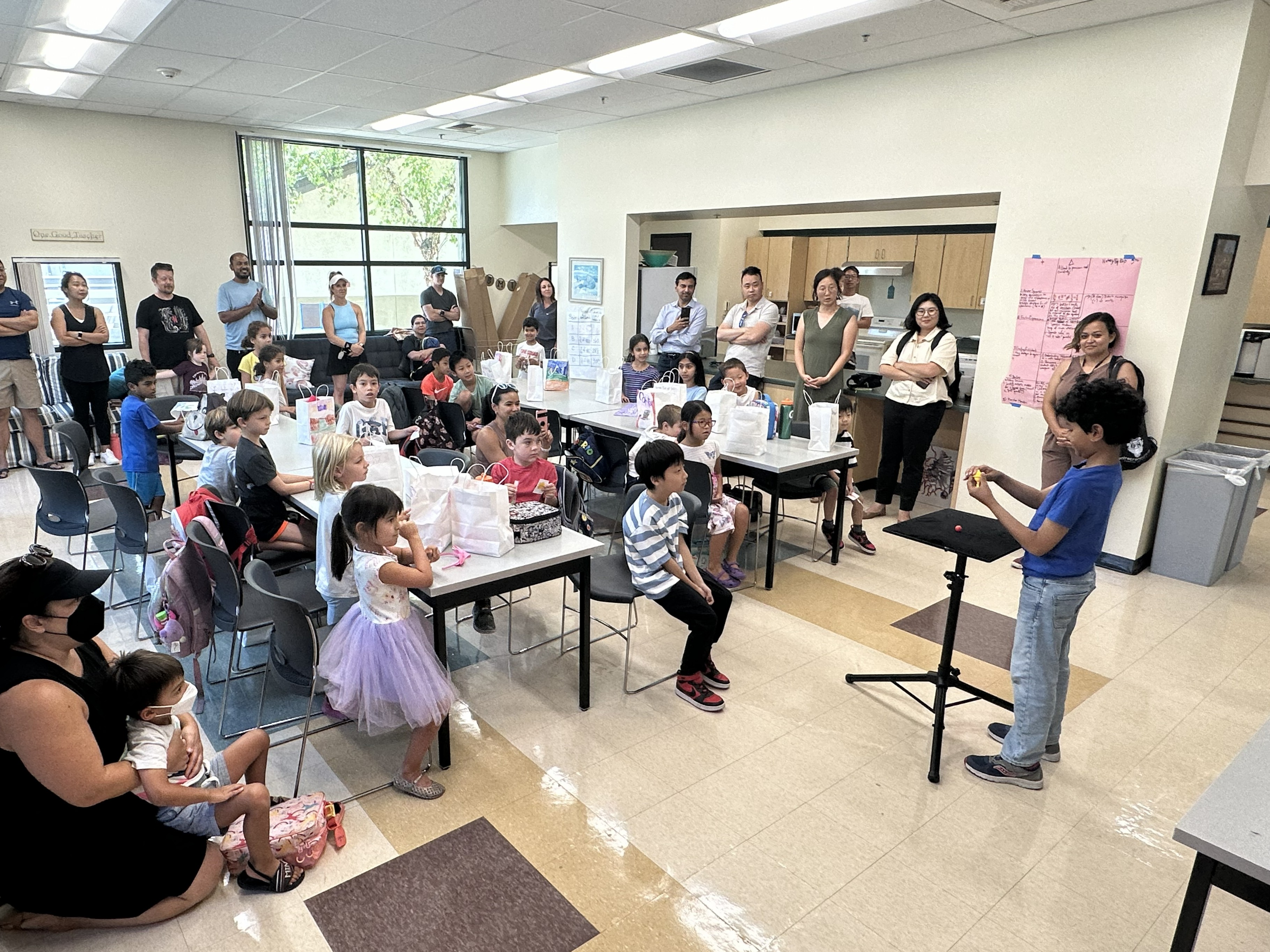 Student performing magic for an audience during a class performance