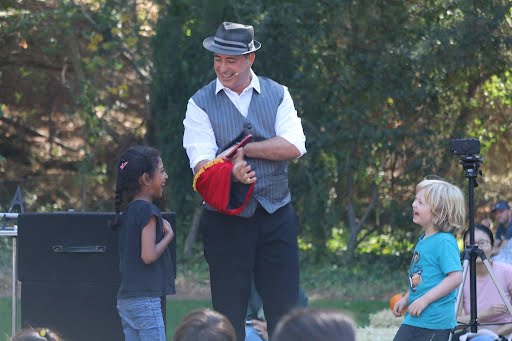 JamesZini involving two children in an outdoor magic show